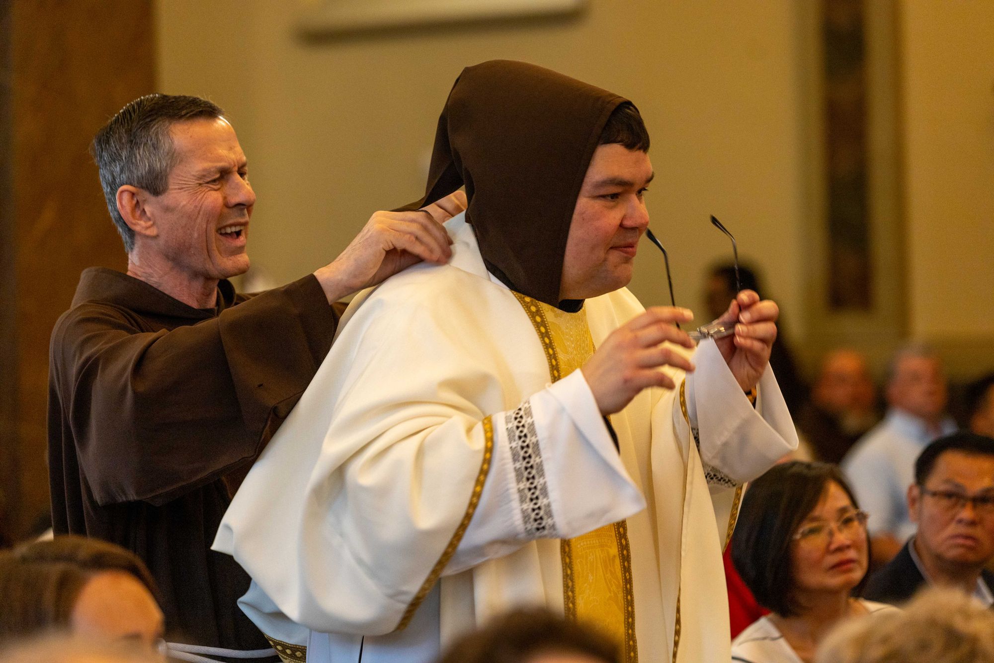Fr. Mike Bertram assists Br. Javier as he dons his priestly vestments for the first time during his ordination to the priesthood.