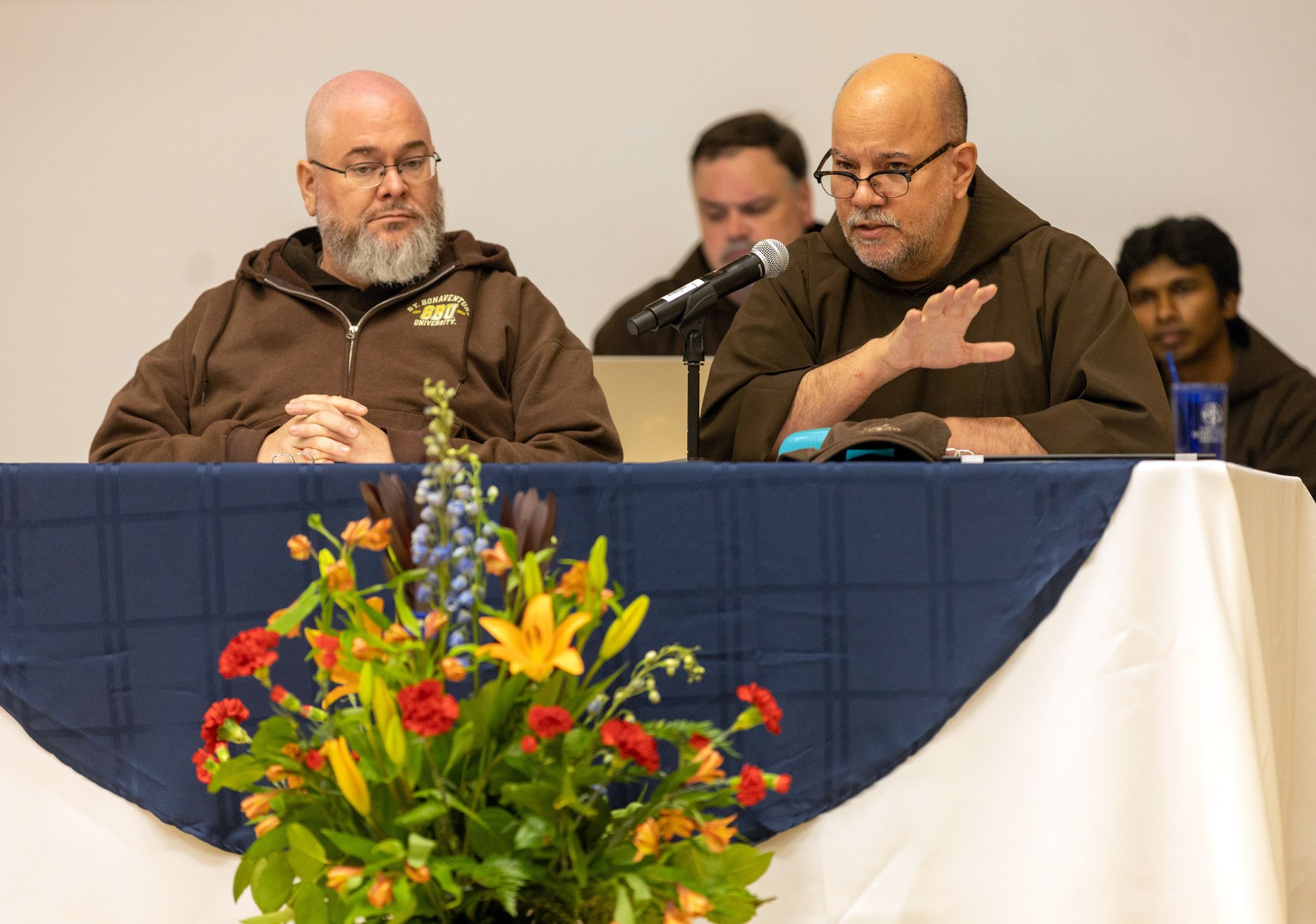 Color interior photo of friar Celestino Arias, OFM Cap. speaks to the friars during the triennial chapter. 