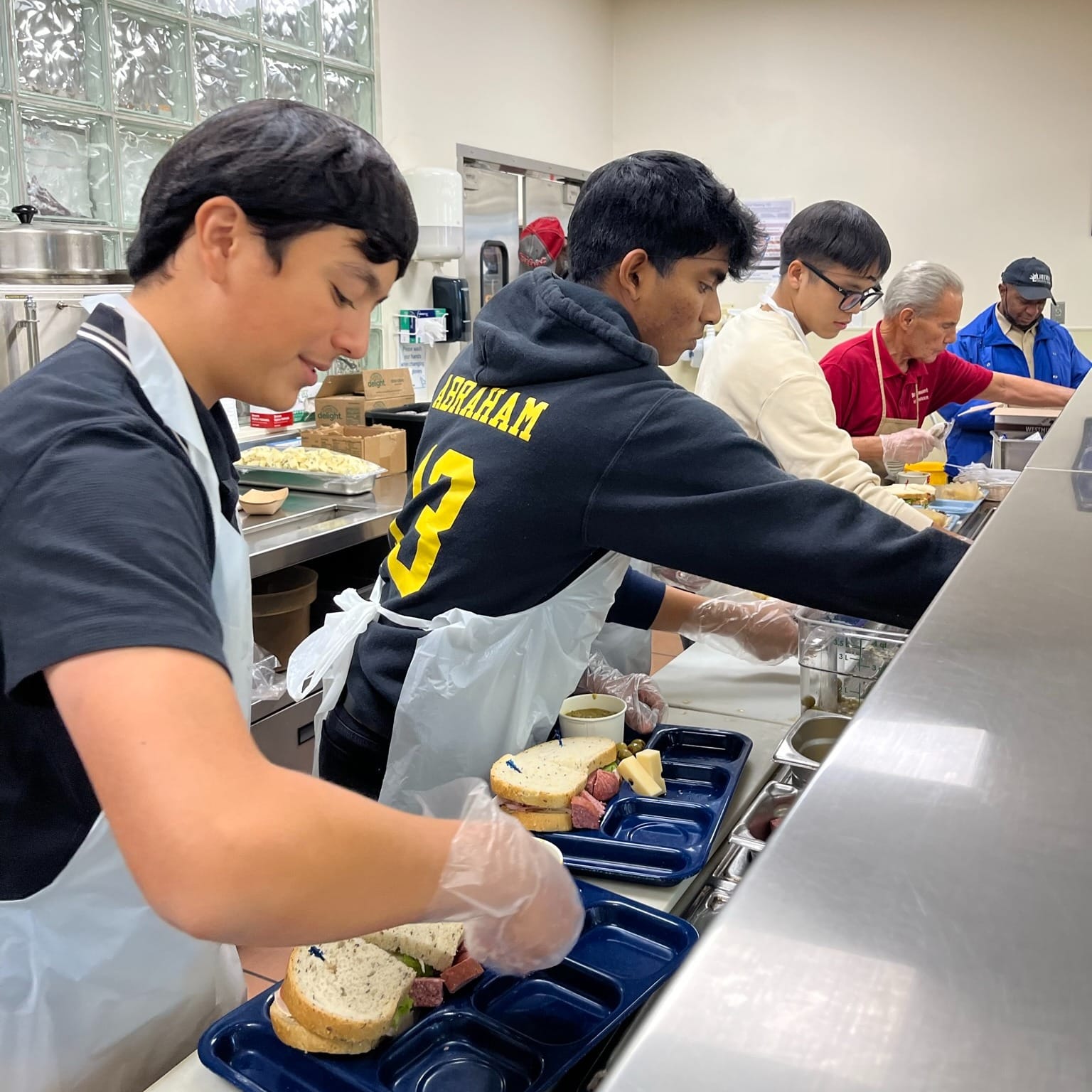 Students from St. Lawrence Seminary High School serve a meal at the Capuchin Soup Kitchen in Detroit.