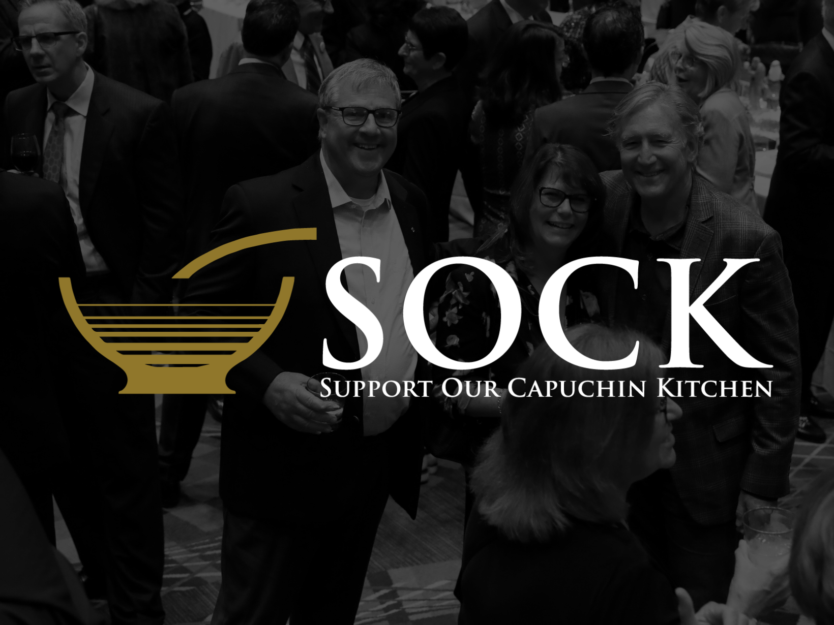 Photograph of the 50th SOCK Dinner fundraiser with the SOCK logo superimposed.