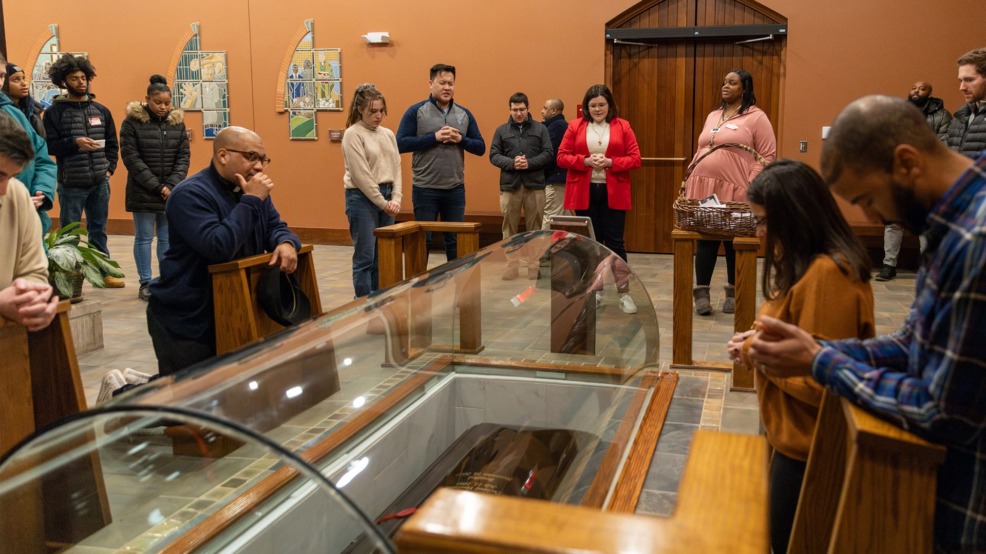 The Solanus Casey YouFra group prays at the tomb of the group's patron, Blessed Solanus Casey.