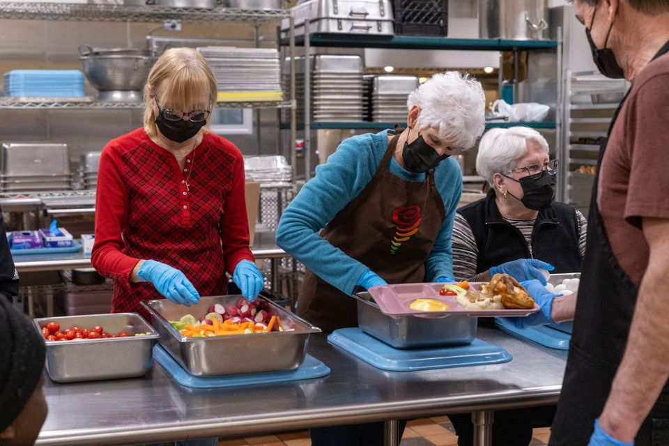 Parishioners from Our Lady of Lourdes serve the meal at Capuchin Community Services, St. Ben's Community Meal