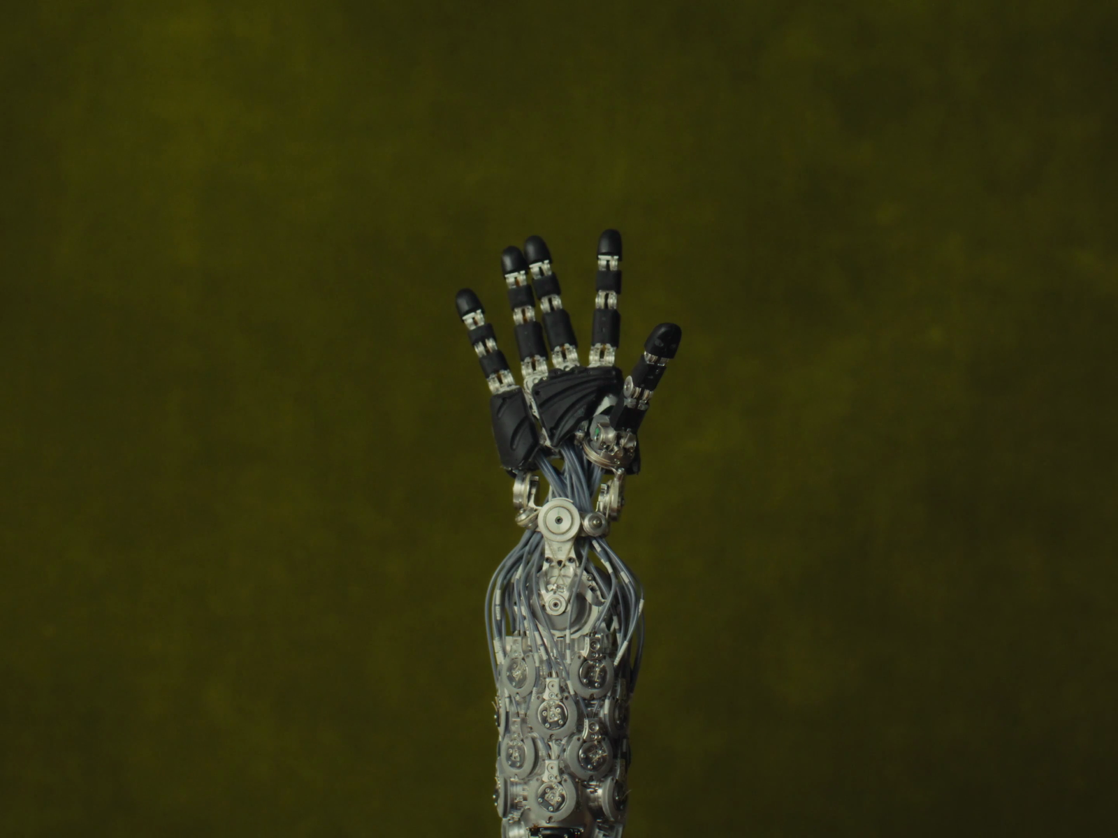 Frame from the captured X video showing the ungloved 1X NEO hand during a close-up manipulation demo.