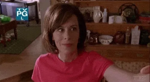 GIF of a woman in a pink shirt yelling excitedly, used to express the chaotic energy around constant social media advice to “do more Reels.” Caption advises artists to find their own rhythm and balance between speed-driven formats and meaningful content.