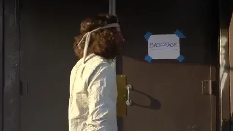 GIF of a woman banging on a locked studio door, symbolizing the tension between curated perfection and raw authenticity on Instagram. Caption encourages artists to use Stories to share their real process and unfiltered moments.