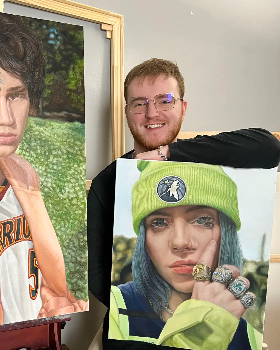 jonathon downing in his studio with billie eilish artwork and  painting, fresh, strong and trending
