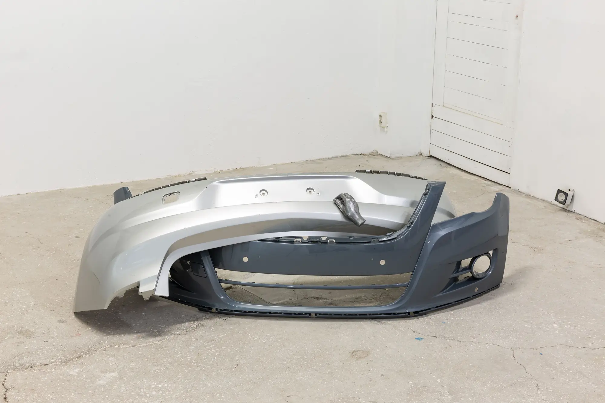 Gallery installation showing Krňanská’s sculptural works with lace-cut metal and car seat interventions at Alkinois Gallery