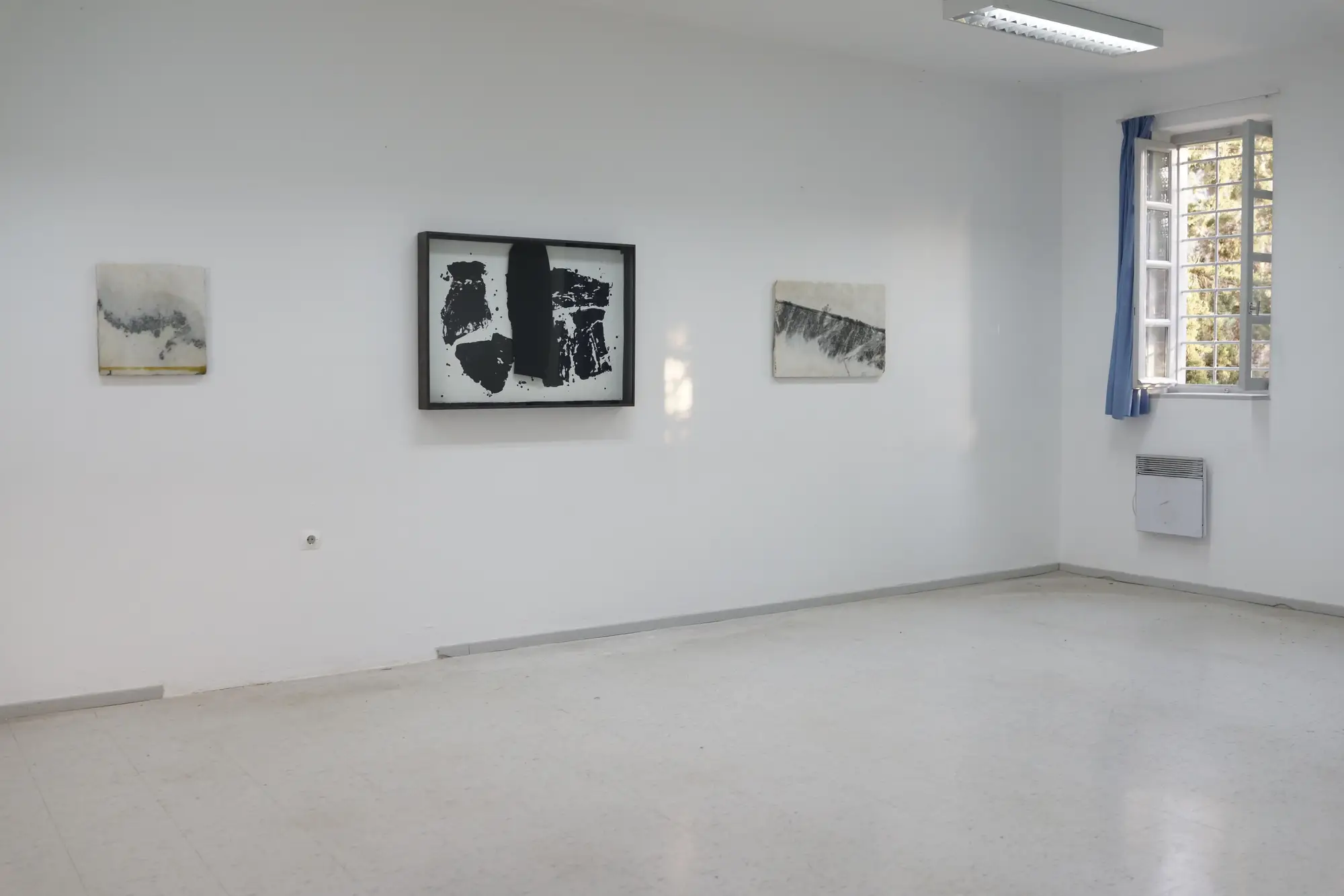 Exhibition view of Hydra School Projects 2025, Lithos Lethe. Artworks by Jannis Kounellis alongside marble works by Brice Marden, reflecting a dialogue between Arte Povera and abstraction within the former Hydra school building, Greece.