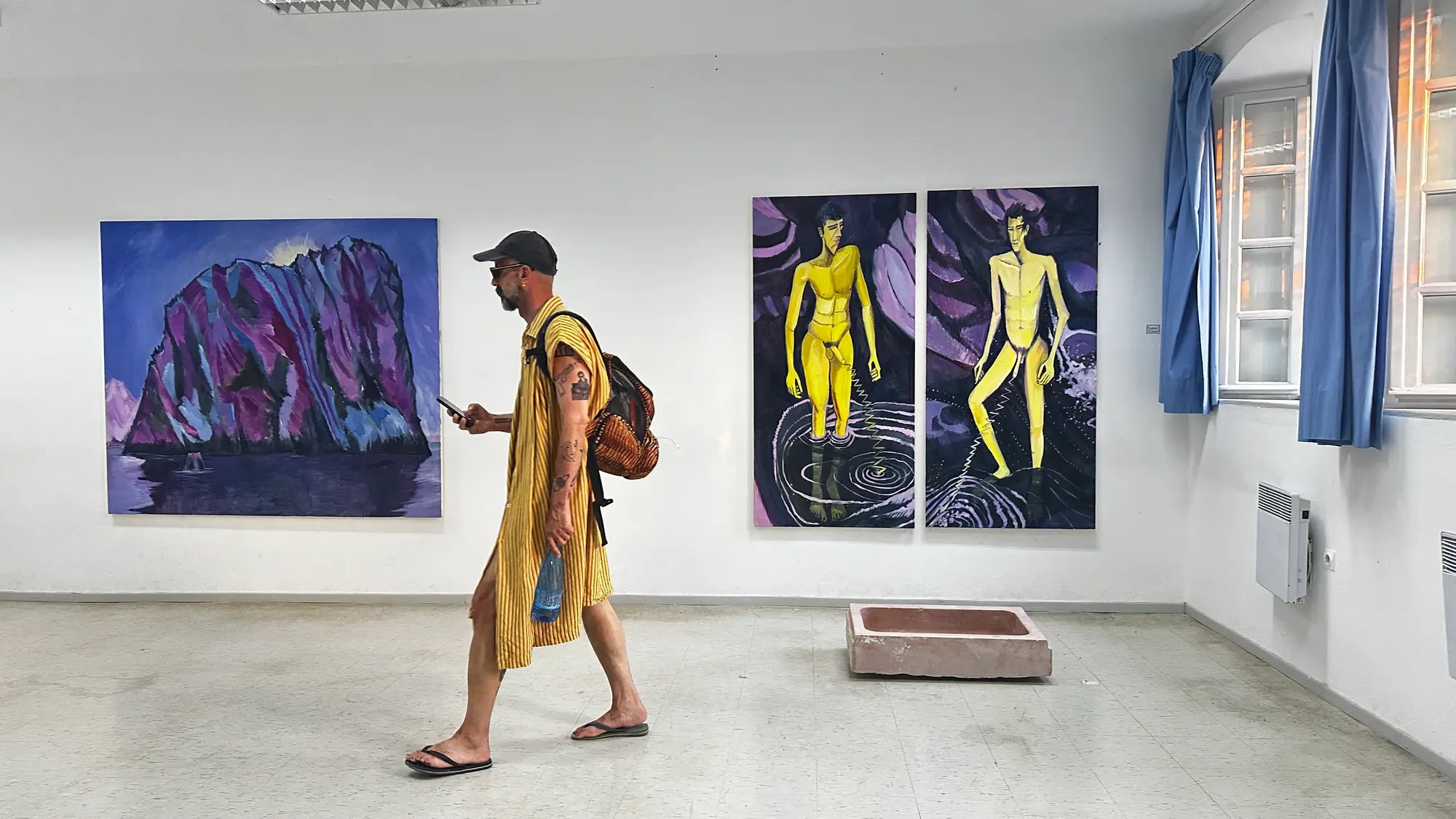 Exhibition view of Hydra School Projects 2025, Lithos Lethe. Paintings by Konrad Zukowski shown together with a marble fountain work by curator and artist Dimitrios Antonitsis inside the former Hydra school building, Greece.