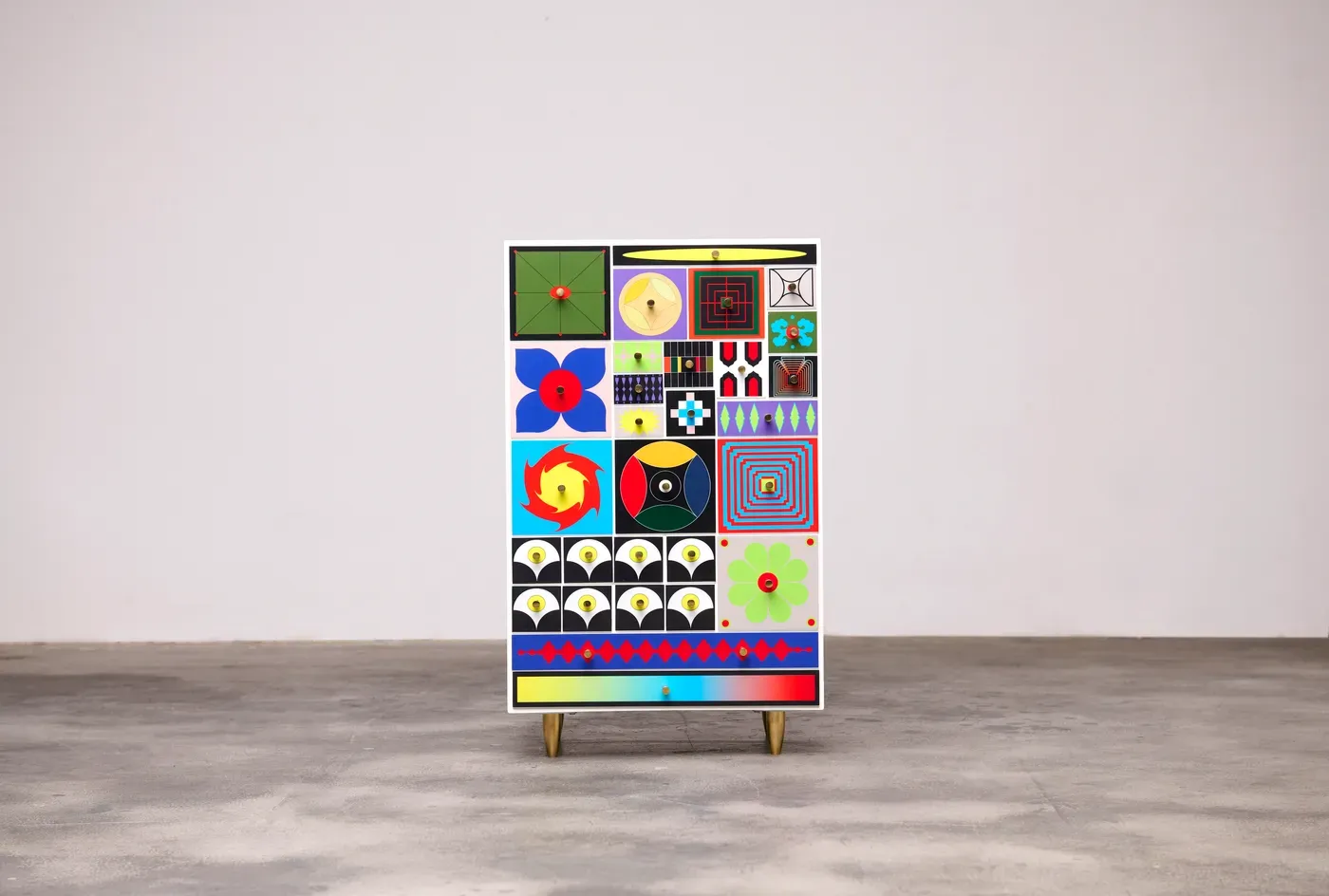 Kumkum Fernando – Front view of the 27th Century Collector’s Cabinet, showing full grid of colorful geometric symbols inspired by temple iconography, psychedelic art, and futuristic design. 