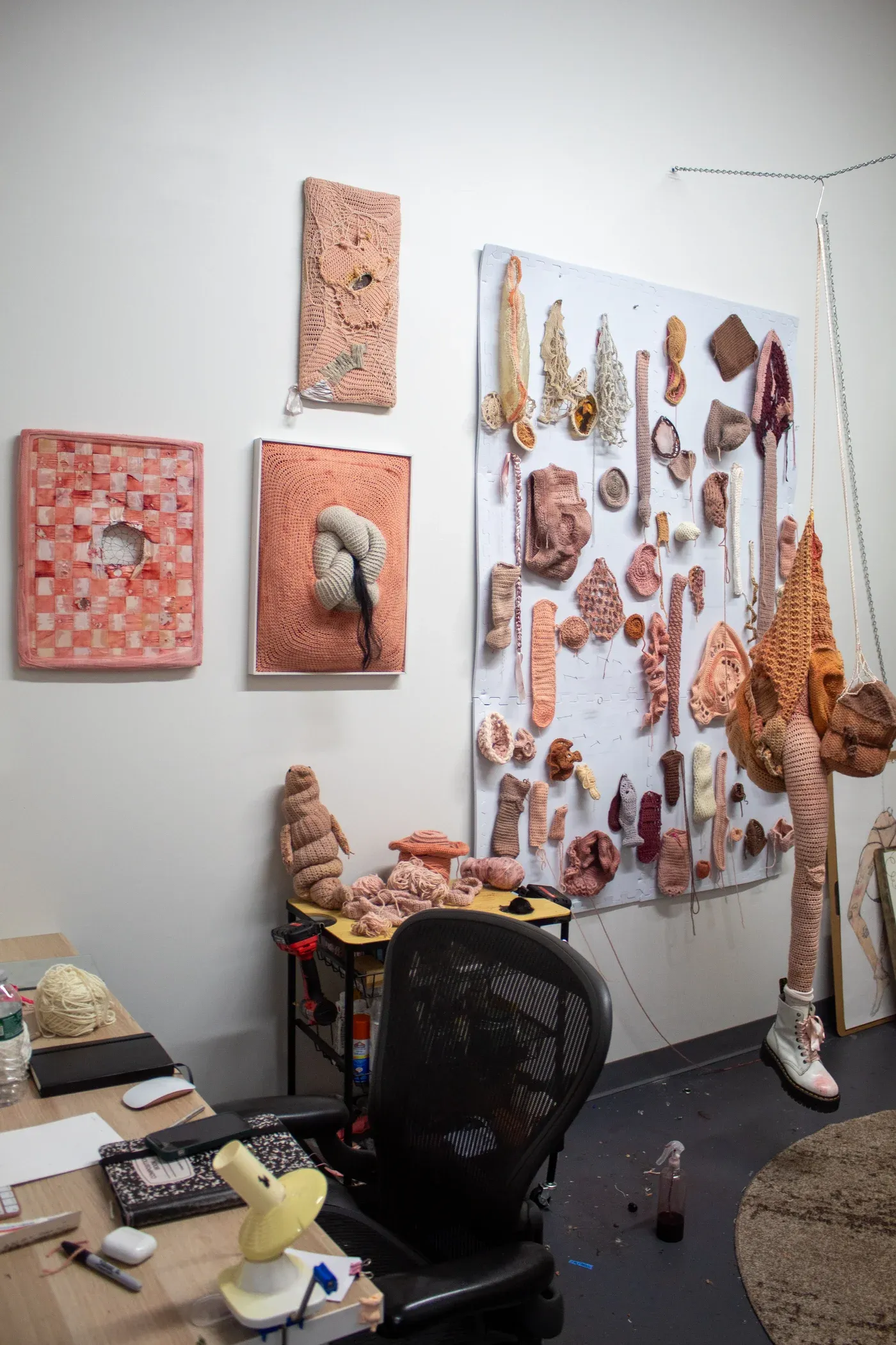 Ophelia Arc studio with textile wall works, crocheted sculptures, and artist desk