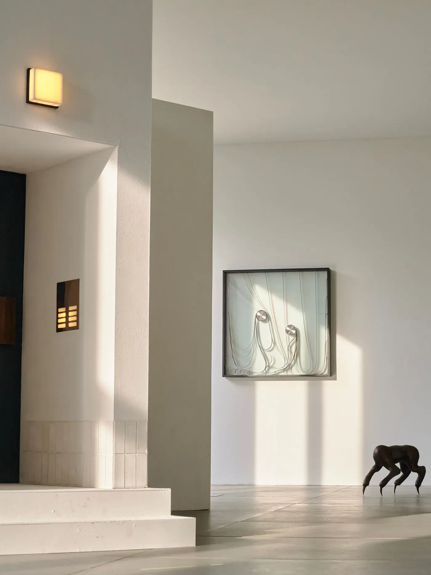 Gallery view at Wehrmühle Biesenthal with multiple works including wall piece and crawling bronze figure, part of Some Degree of Friction 2025.