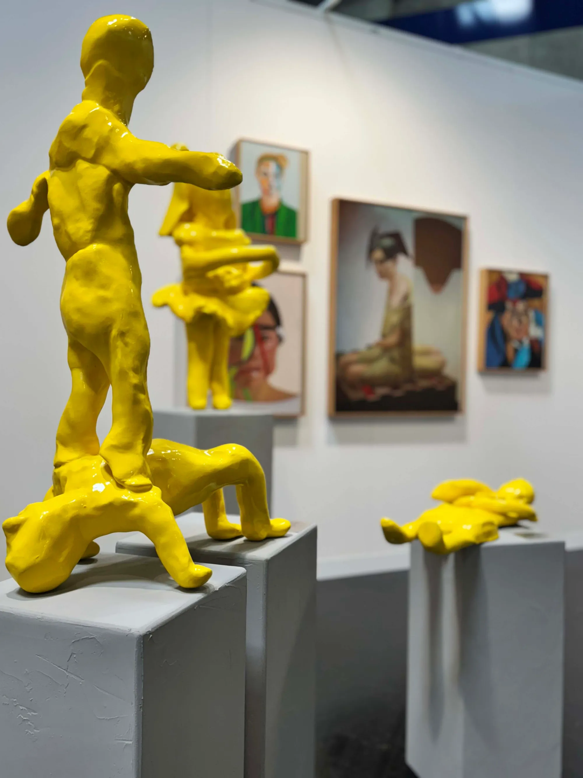 Contemporary Vienna art fair 2025, Messe Wien: installation by Christian Jankowski from Modeled City (Geknetete Stadt); several yellow human figures displayed on white plinths at Vienna Contemporary.