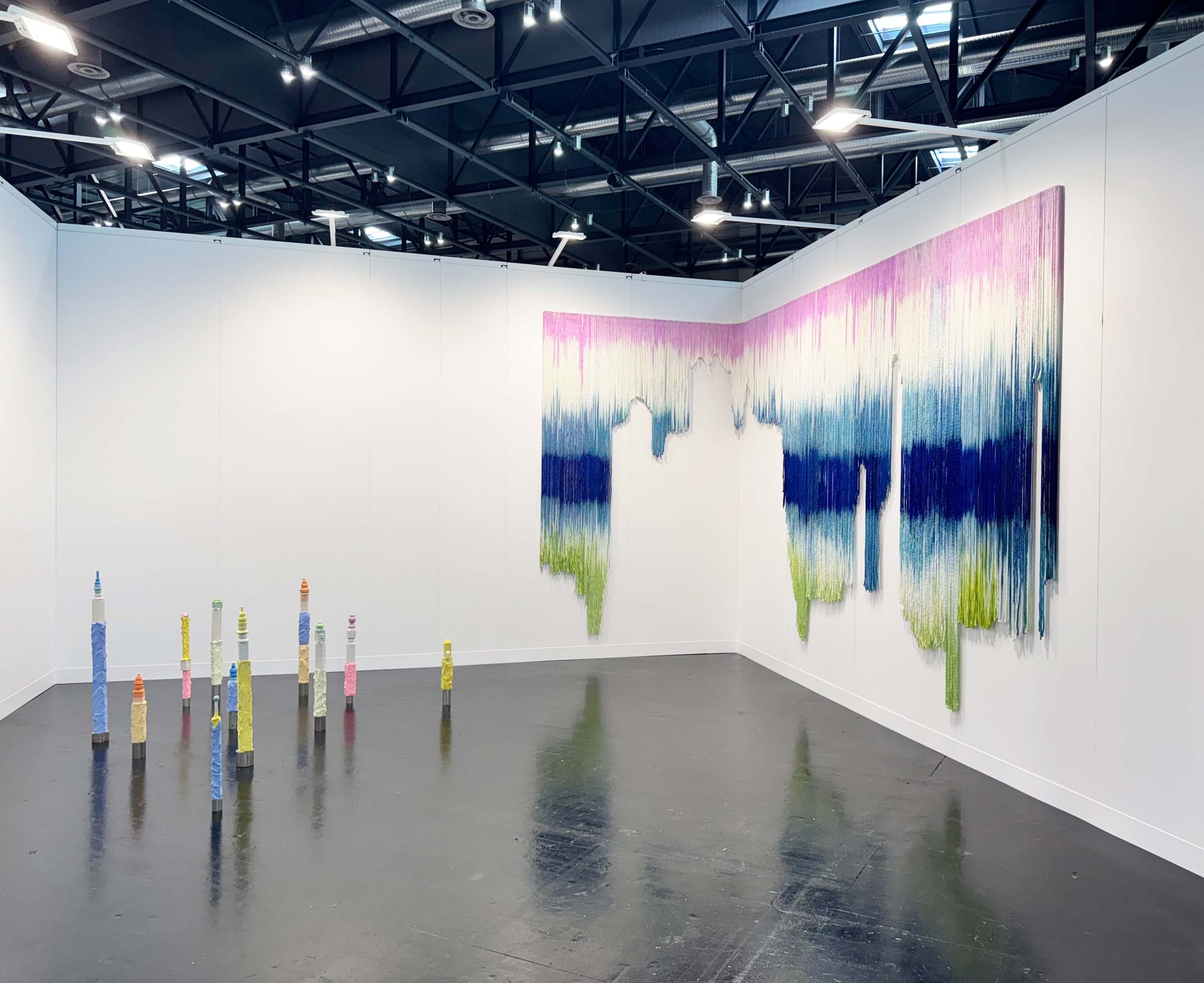 Teresa Kasalicky, textile wall installation with colored strands and floor columns, Galerie 3, Vienna Contemporary 2025.
