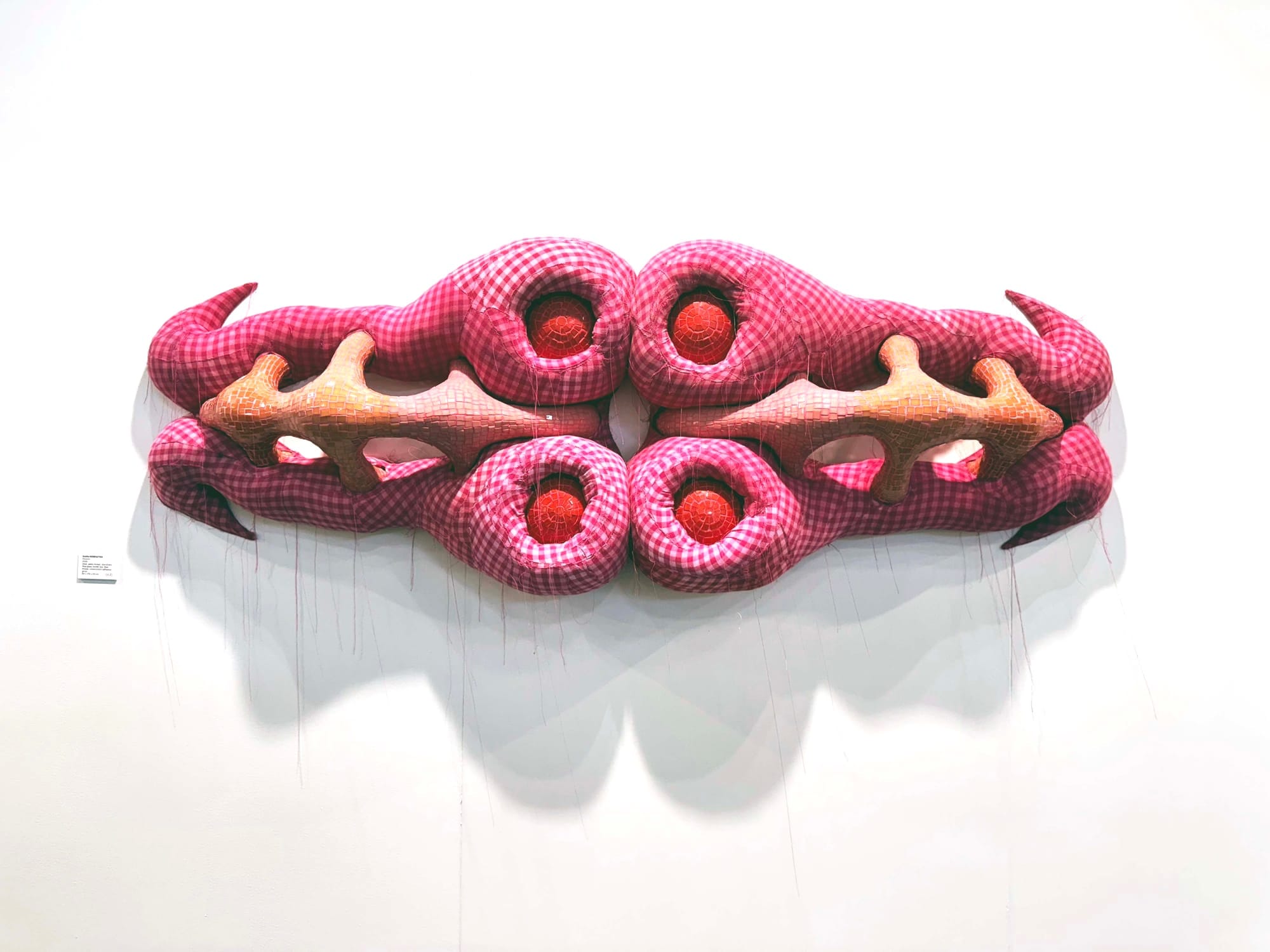 Zsófia Keresztes, sculptural wall piece with pink gingham forms and red orbs, acb Gallery Budapest, Vienna Contemporary 2025.
