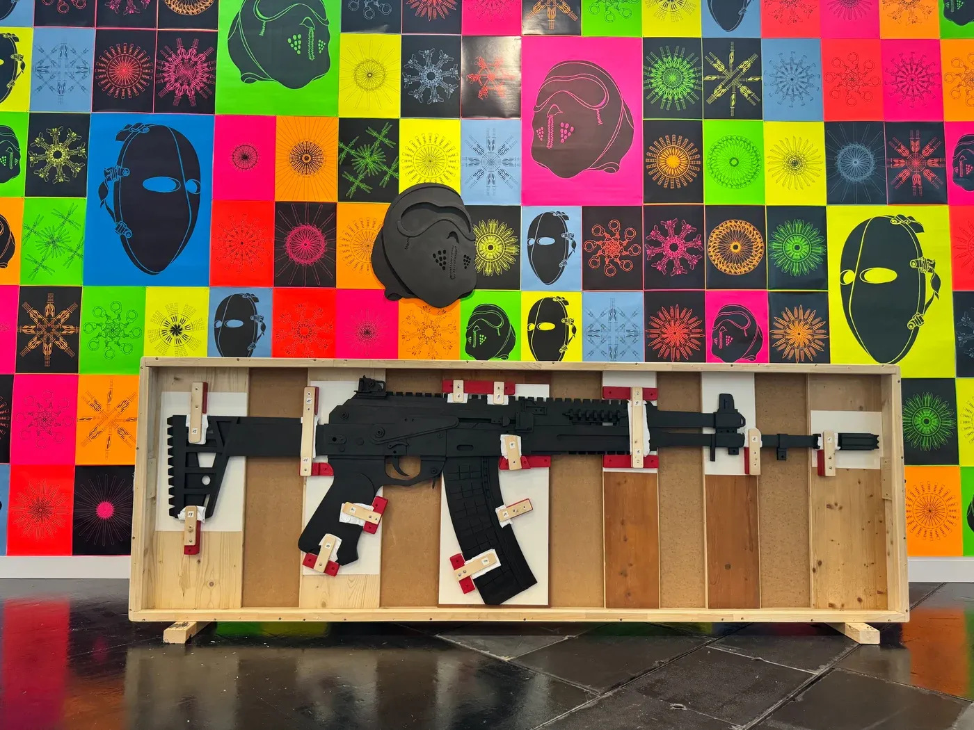 Franz Kapfer, installation with mask prints and boxed rifle silhouette, Gregor Podnar Gallery, Vienna Contemporary 2025.