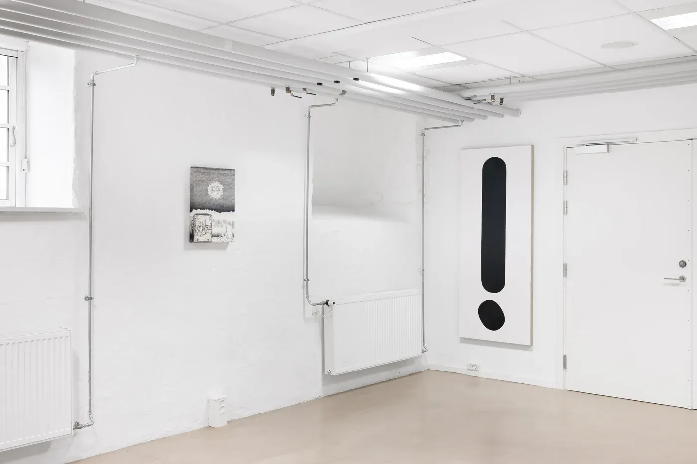 Stefan Bakmand: Exhibition view at Yawn Cantina with monochrome wall work and framed drawings, 2025. Photo Mikkel Kaldal. Image courtesy the artist.