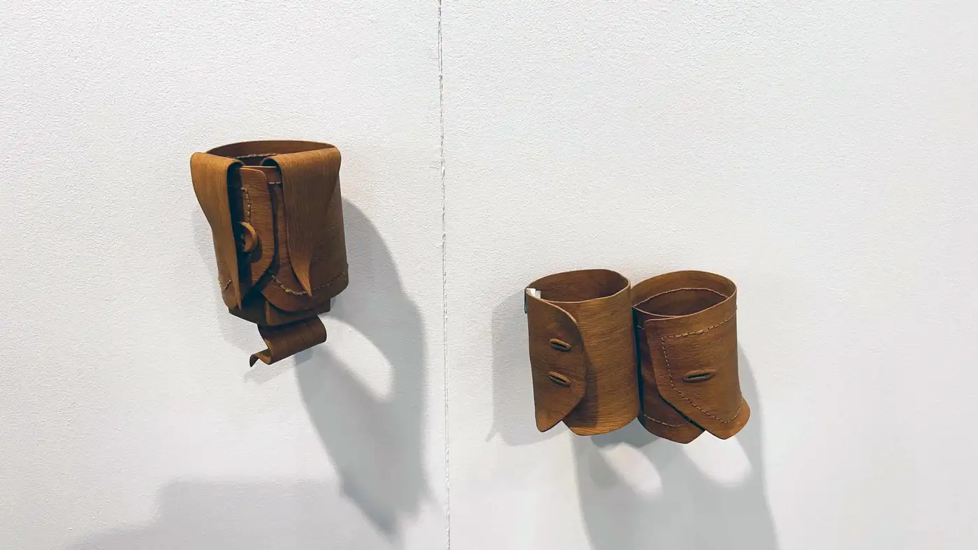 Tobias Izsó, wall-mounted wooden sculptures resembling cuffs, Christine König Gallery, Vienna Contemporary 2025.