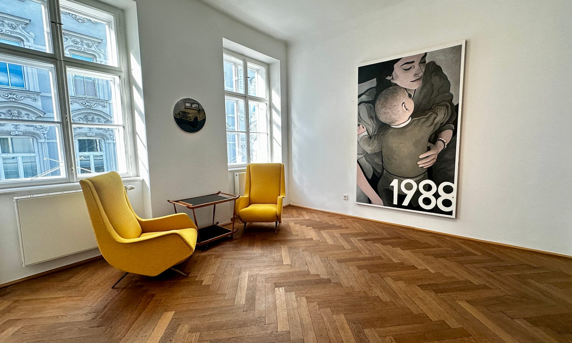 Tin Trohar Artist , exhibition view curated by Alexander Giese and Christof Habres . Kunst und Schnittlauch. symbosium. Every Friday. Room view at Klubhaus showing a small round Jeep painting and a large mother-and-child painting from “1996.