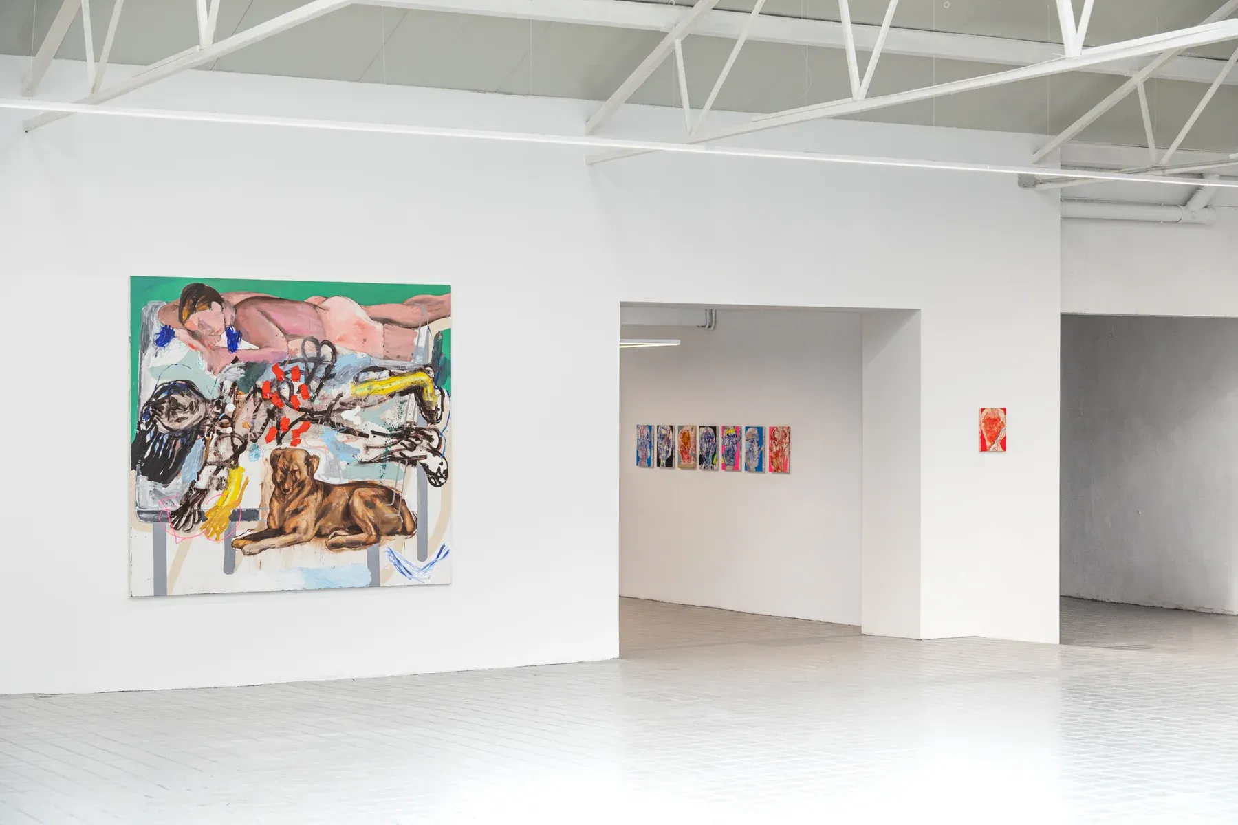 Installation view of Manuel García Fernández’s 2025 solo show Dog Bed Games at Marc Bibiloni Gallery, Madrid. Large figurative canvas with dog on left, smaller works in hallway.