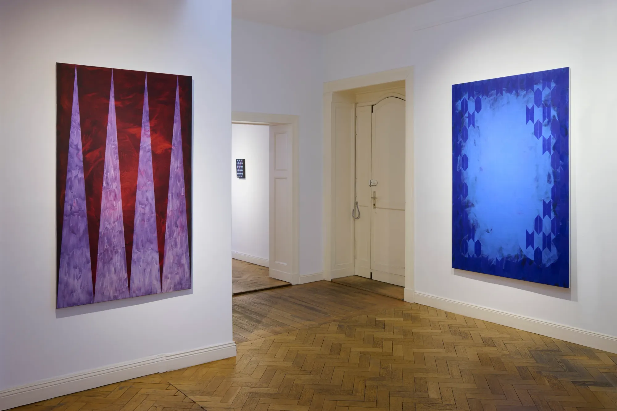 Matthias Esch, Map and Territory exhibition view II, abstract geometric paintings in red and blue tones on gallery walls, Berlin-based contemporary artist exploring structure and ornament.