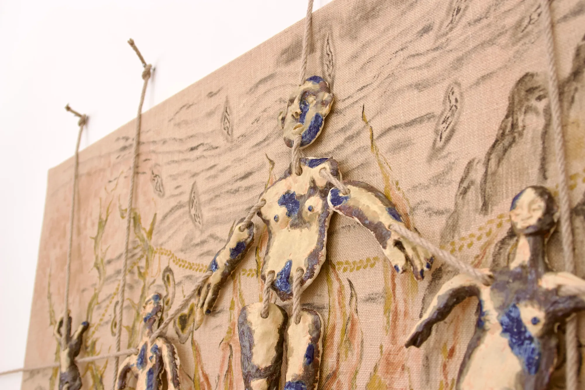 Detail of Harmony in Motion by Seung-yeon Jung, ceramic and jute relief showing linked figures and tactile surface textures, Vienna, 2025.