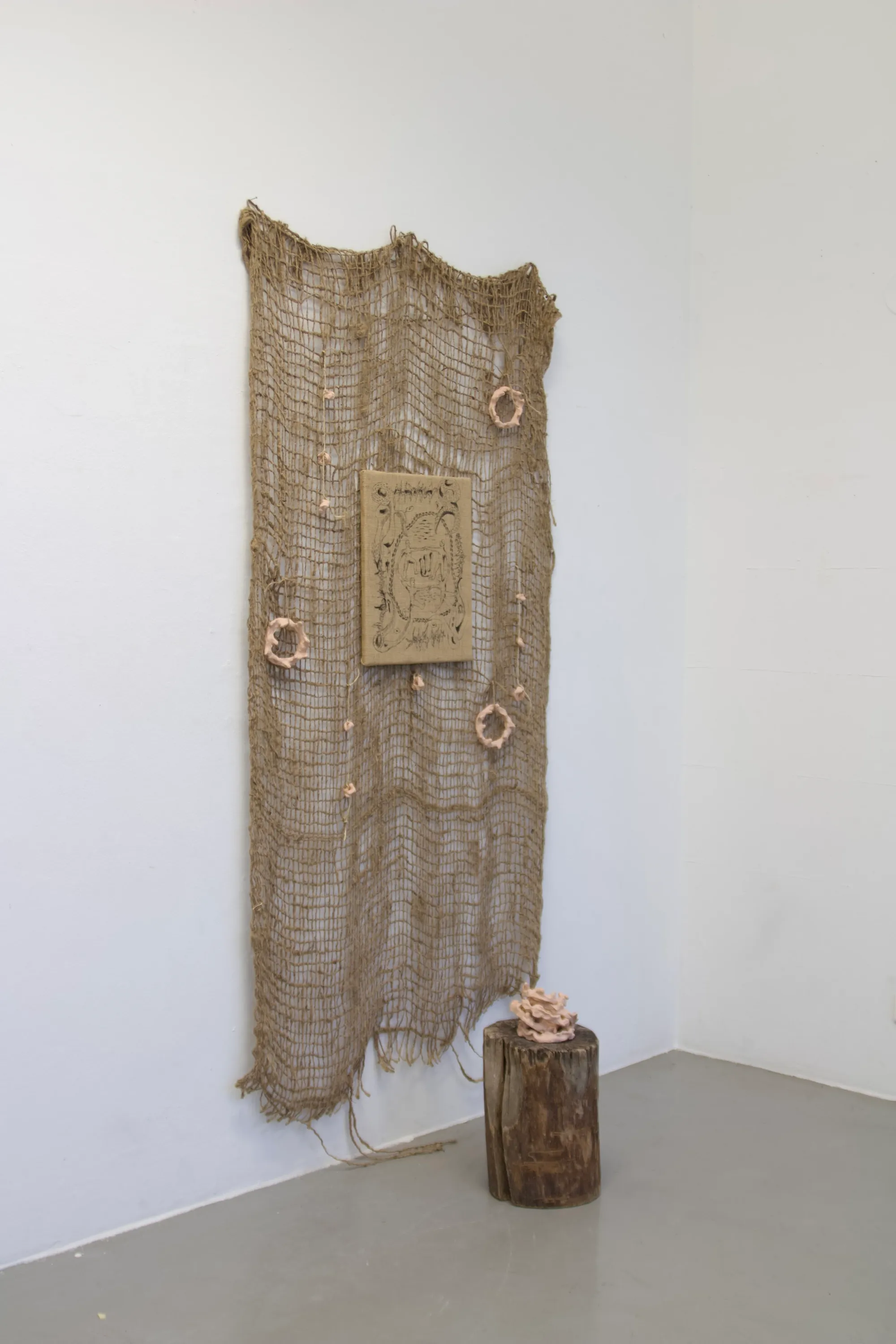 Seung-yeon Jung, The Harmony in a Book Left Unread, 2025, wall installation with jute fabric and ceramic forms exploring balance and material dialogue, Vienna.