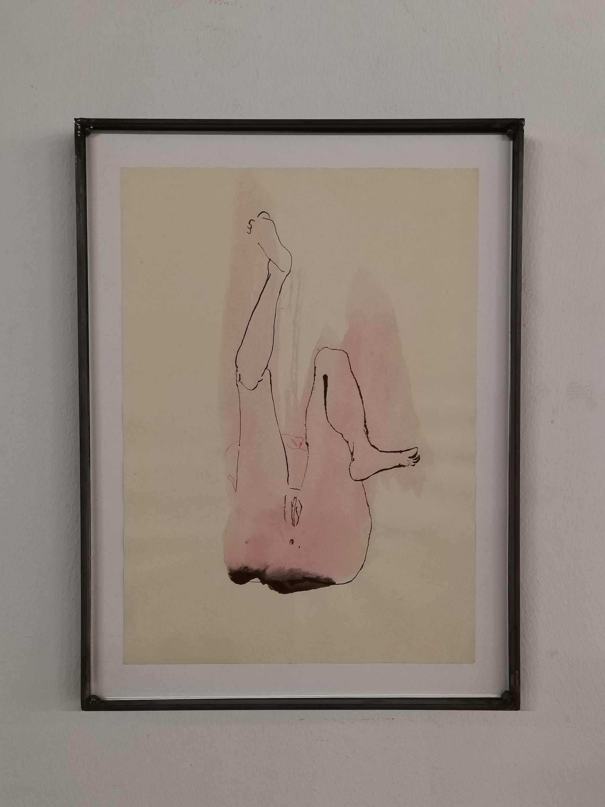 Ruth Devriendt’s 2023 work Frivolity, a watercolor, pencil and ink drawing on paper, framed and displayed on a light wall. Image courtesy of the artist.