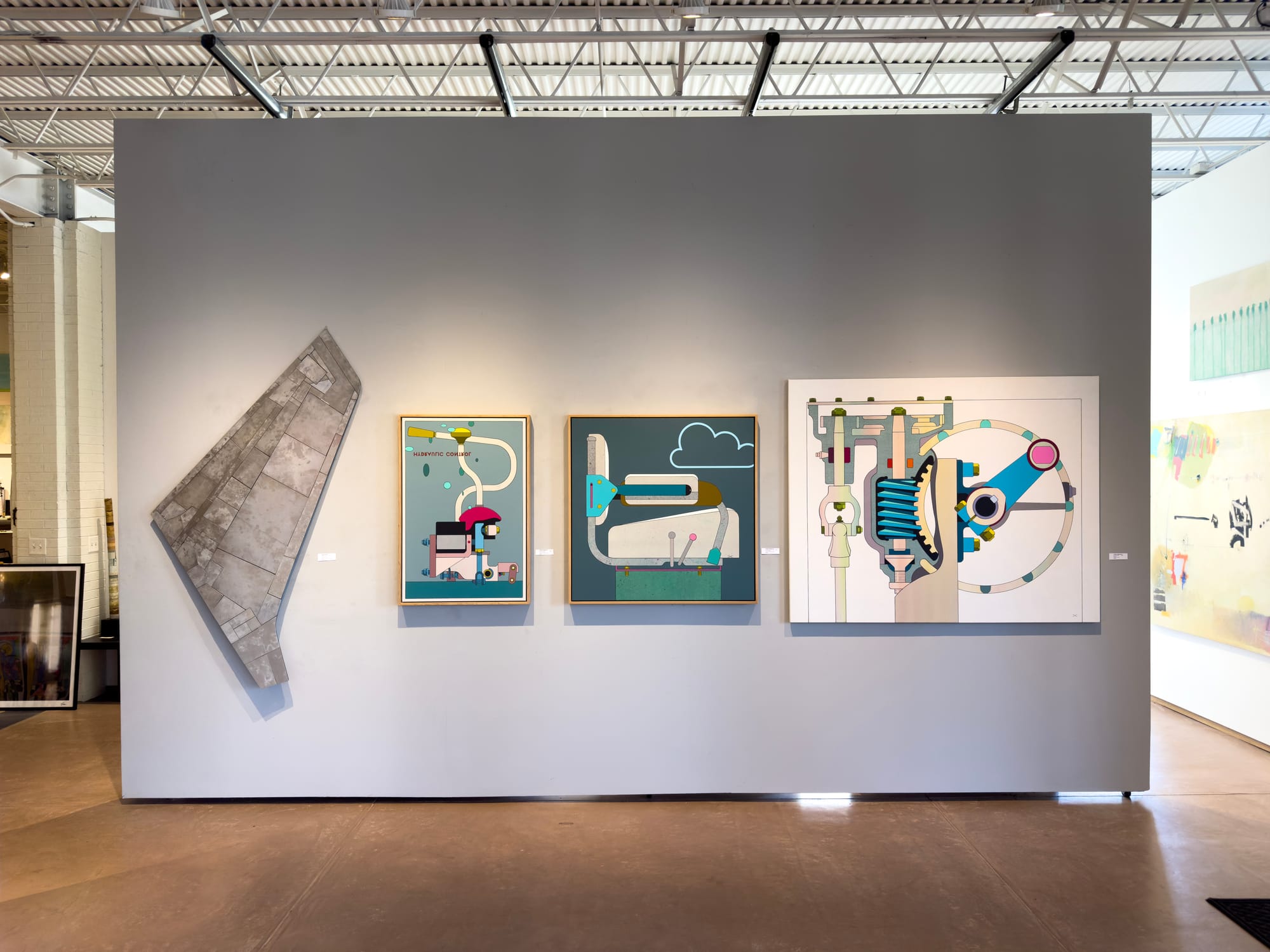 Installation view of Chris Cassimatis works at Modern Arts Midtown in 2024, showing three geometric paintings and one sculptural wall piece displayed on a grey gallery wal