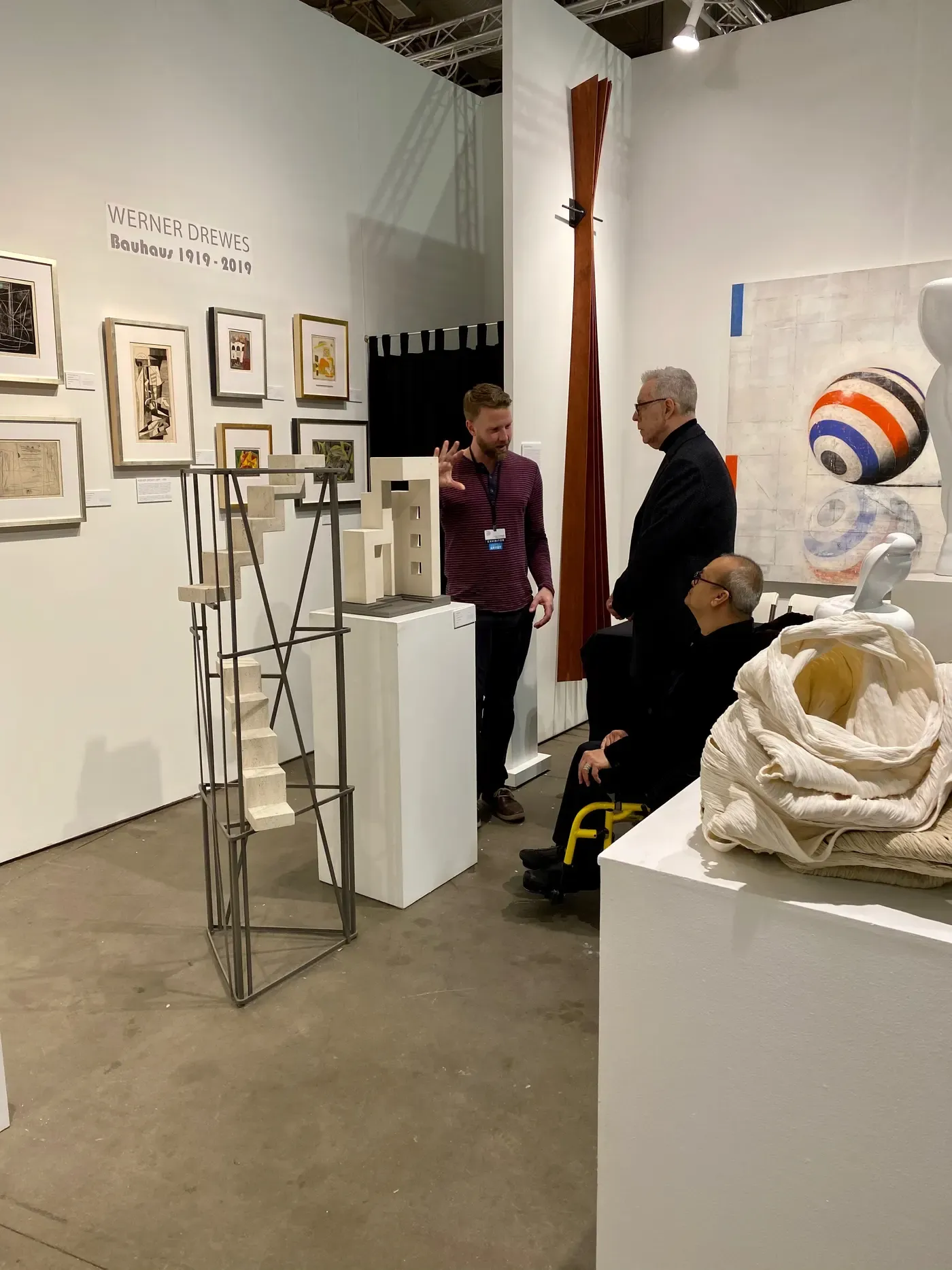 William Havu Gallery booth at SOFA Chicago showing Chris Cassimatis in conversation with visitors, alongside sculptural works and framed pieces on display. Image Courtesy of the Artist and the Gallery