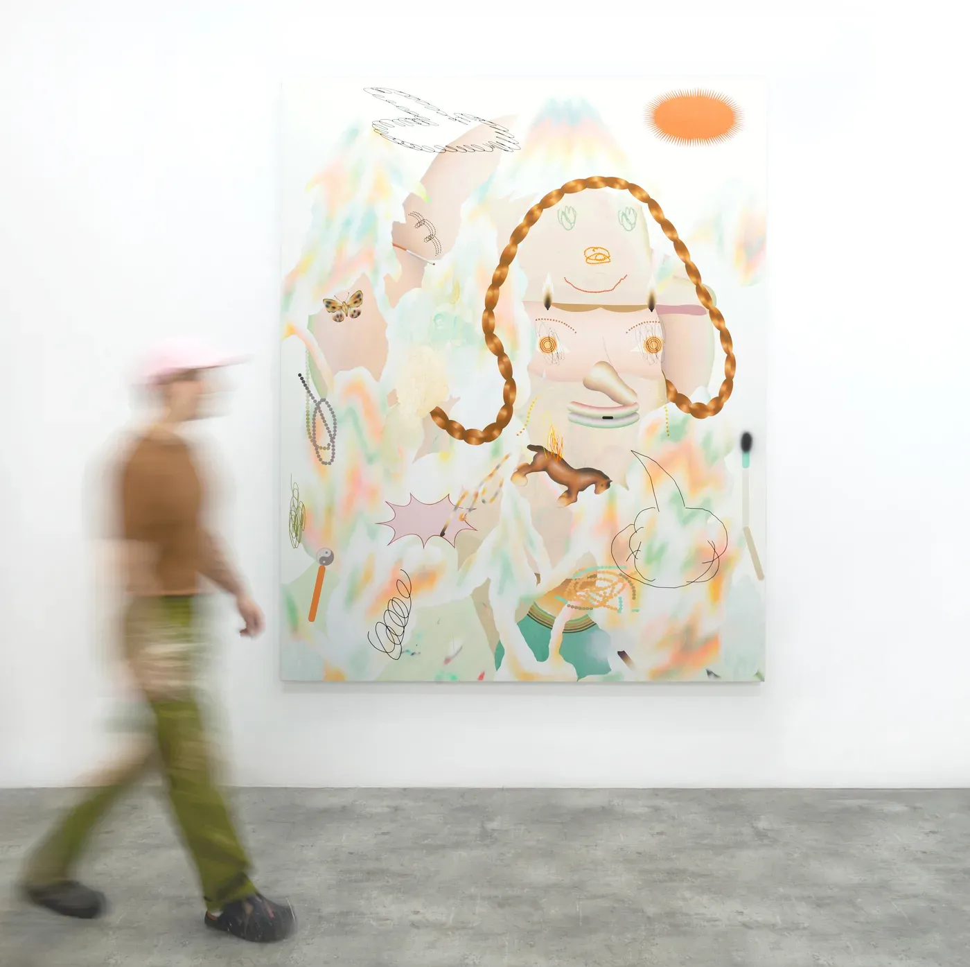 A blurred figure walks past a large surreal painting by Grip Face featuring soft pastel tones, braids, floating forms, and symbolic elements. The work, part of the exhibition Levantamientos curated by @ventana_project, examines digital identity and the instability of self