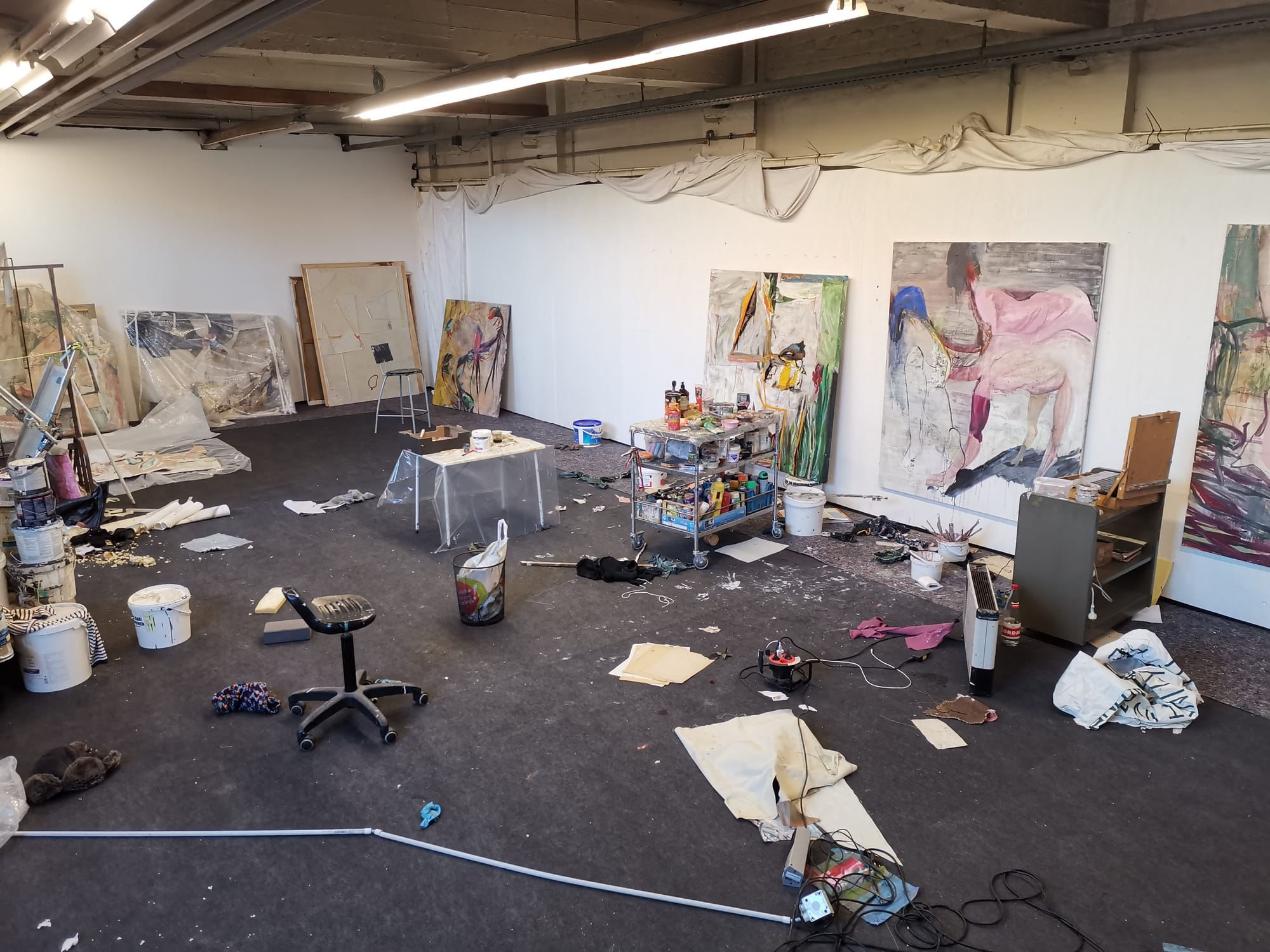 Ruth Devriendt’s studio installation view from 2025, showing large canvases, painting materials and works in progress arranged across the space. Image courtesy of the artist.