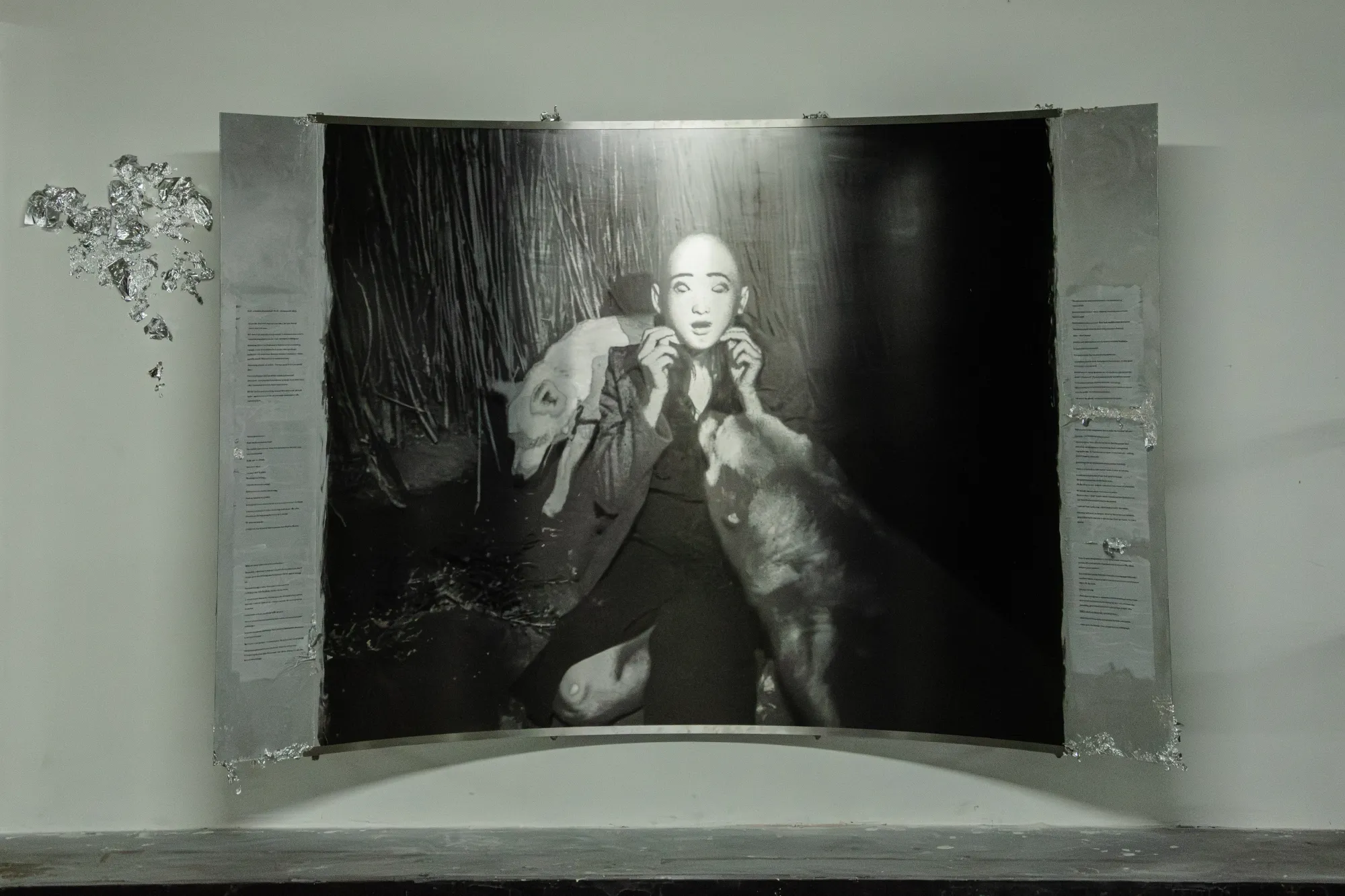 Installation view of After Unrast by Nadine Karl at Kunsthalle Düsseldorf, showing a large black-and-white photographic work with sculptural and text elements.