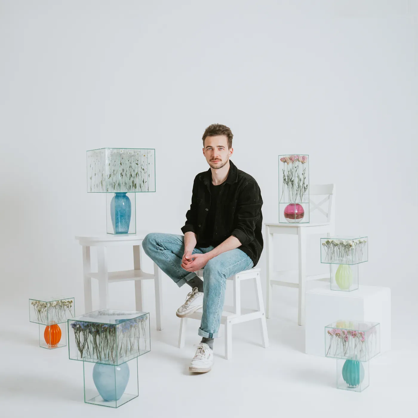 Sandor körei , artist with his glass boxes and flower, portrait , catapult munchies art club studio image