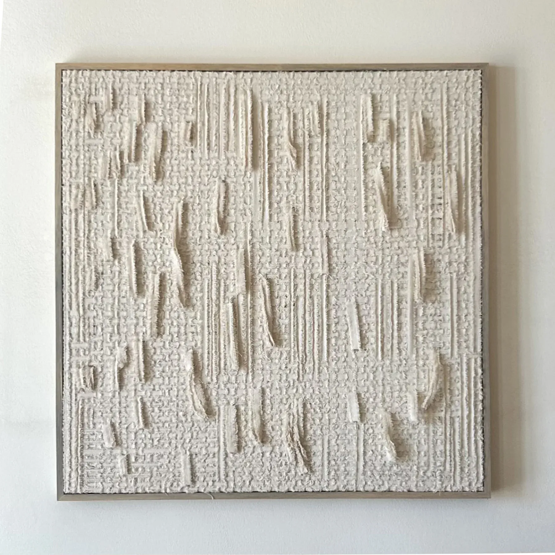 Textural canvas-on-canvas artwork by Avraam Hirodontis, showing raised woven ridges and subtle vertical interruptions across a pale surface.