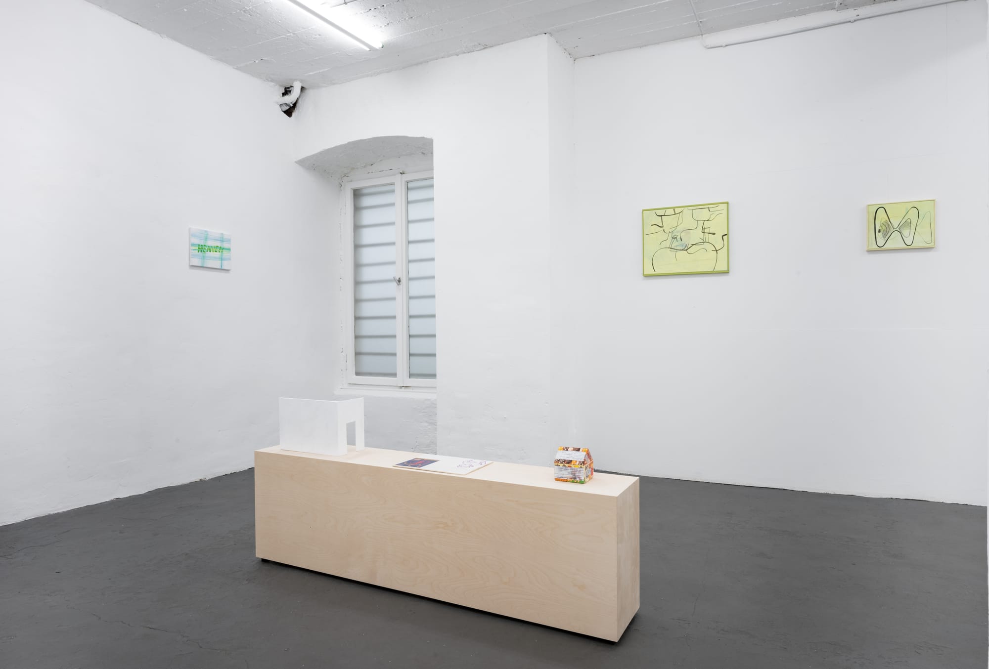 on pale walls and a wooden plinth in the center. Photo by Martin Plüddemann