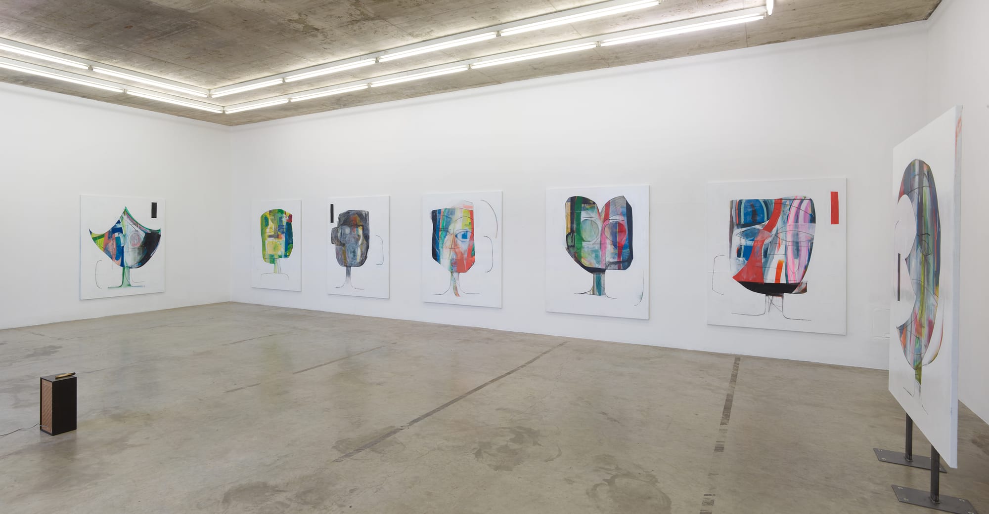 Installation view of Tom Król’s exhibition at Neuer Aachener Kunstverein featuring a series of large-format figurative paintings displayed along white gallery walls