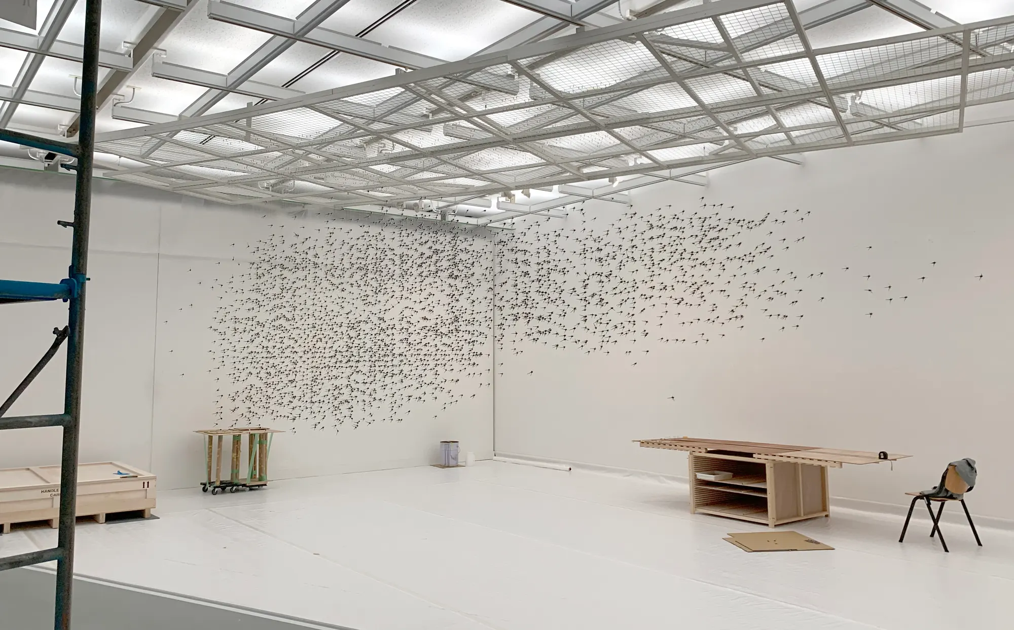 目[mé] art collective Japan, movements (2019) large-scale wall installation forming a drifting cloud of suspended elements across a white exhibition space at Chiba City Museum of Art.
