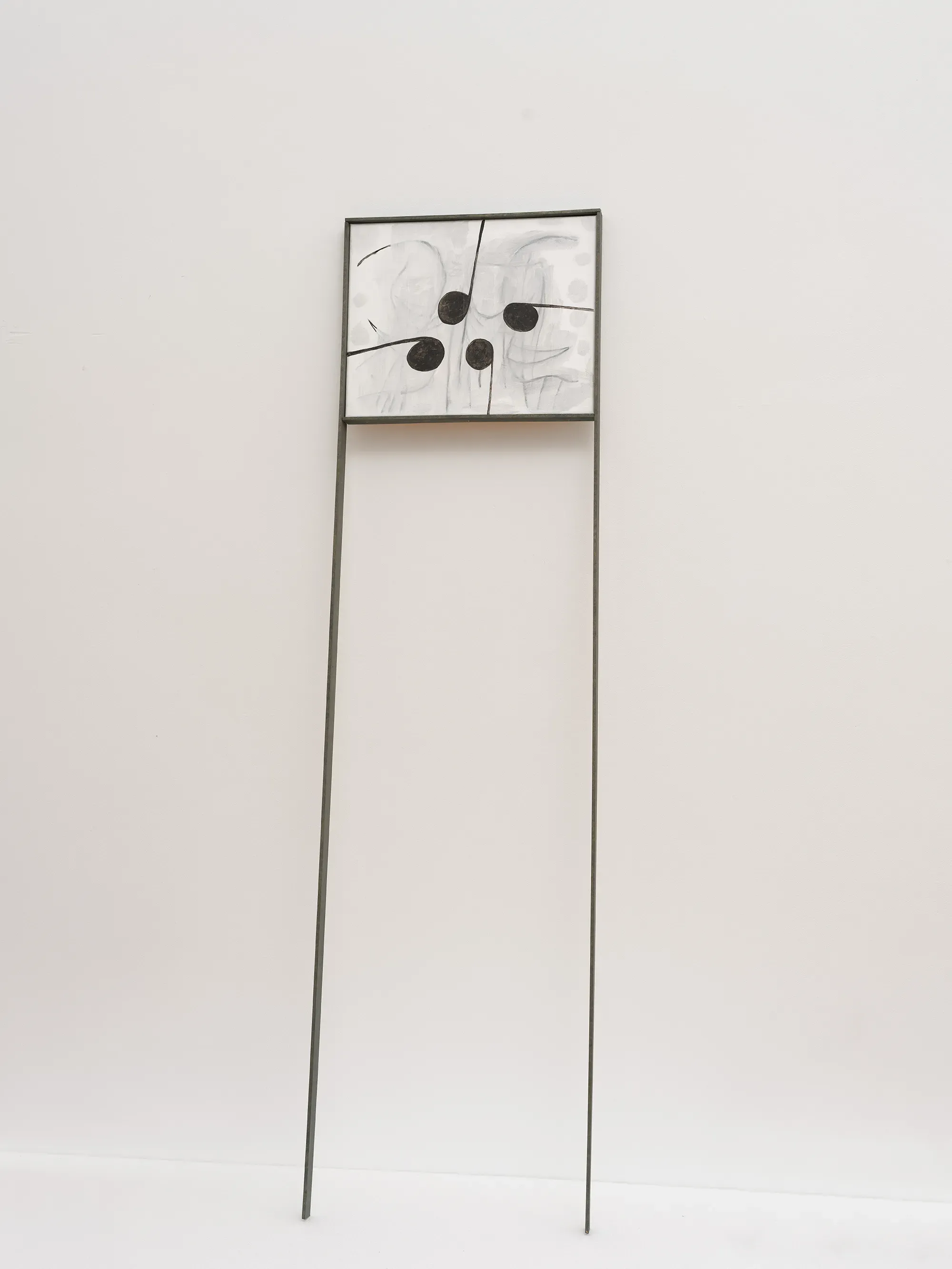 Tom Król, “Untitled,” 2023, mixed media painting mounted on a tall minimal metal stand, featuring four black circular forms and fine linear marks on a pale surface.
