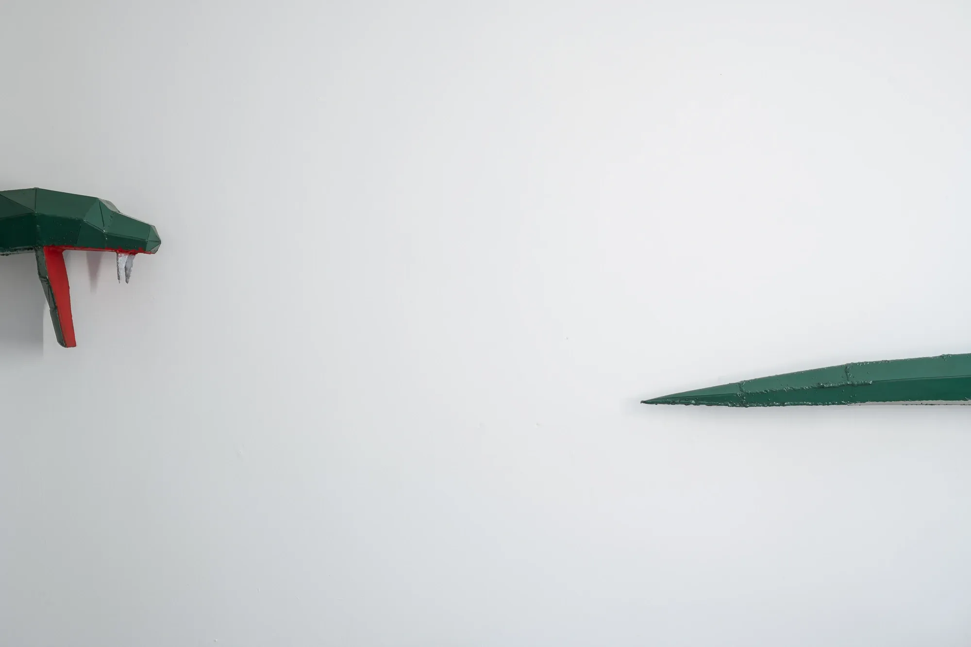 Liudvikas Kesminas current exhibition, artwork detail, metal snake in green and red, tail and head