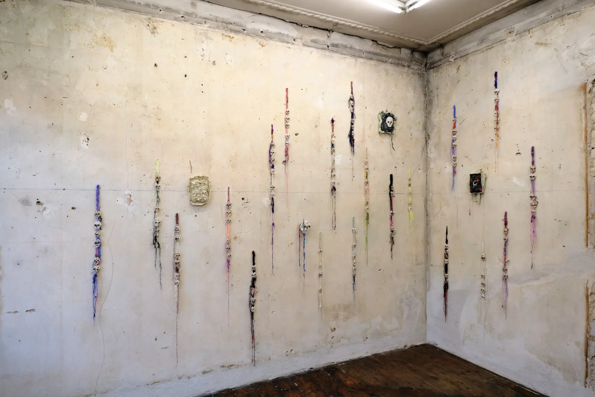 Installation view of Echo by Julie Wittrup at HAGD Contemporary showing multiple textile and ceramic wall works