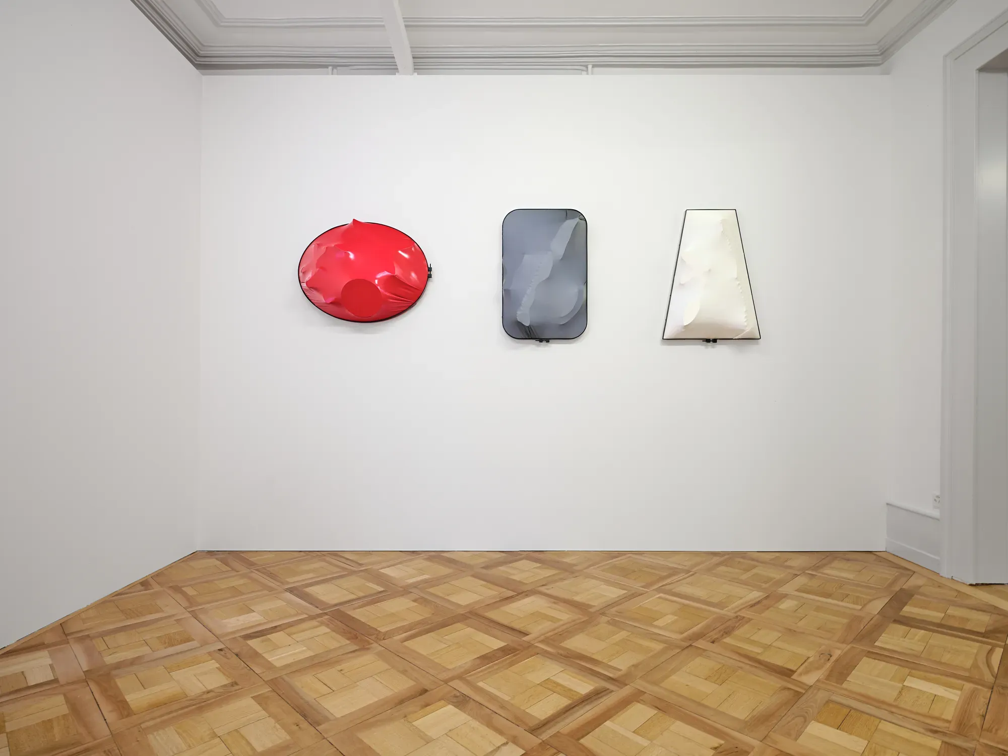 Sonia Kacem textile wall works in three sculptural forms mounted on a gallery wall at Villa Bernasconi in the exhibition “Stitches: A Haunted House and Other Ghost Stories”, 2026.