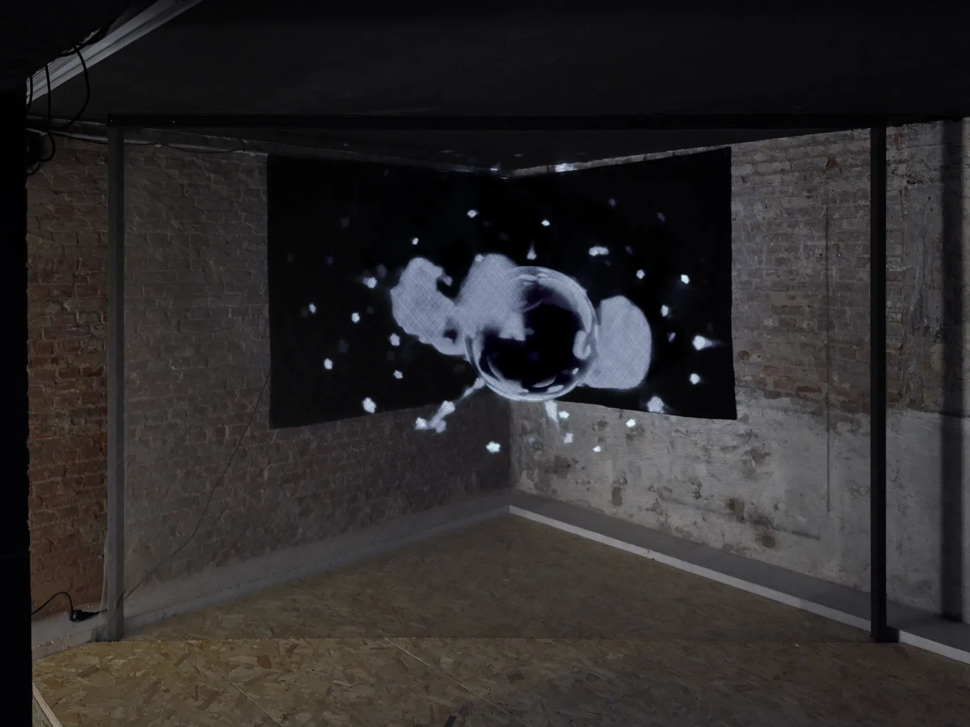 Installation view of Banks Violette’s video work Untitled (Universal Pictures), 2026, shown in a darkened brick-walled space at TICK TACK, Antwerp, featuring a projected black-and-white moving image.