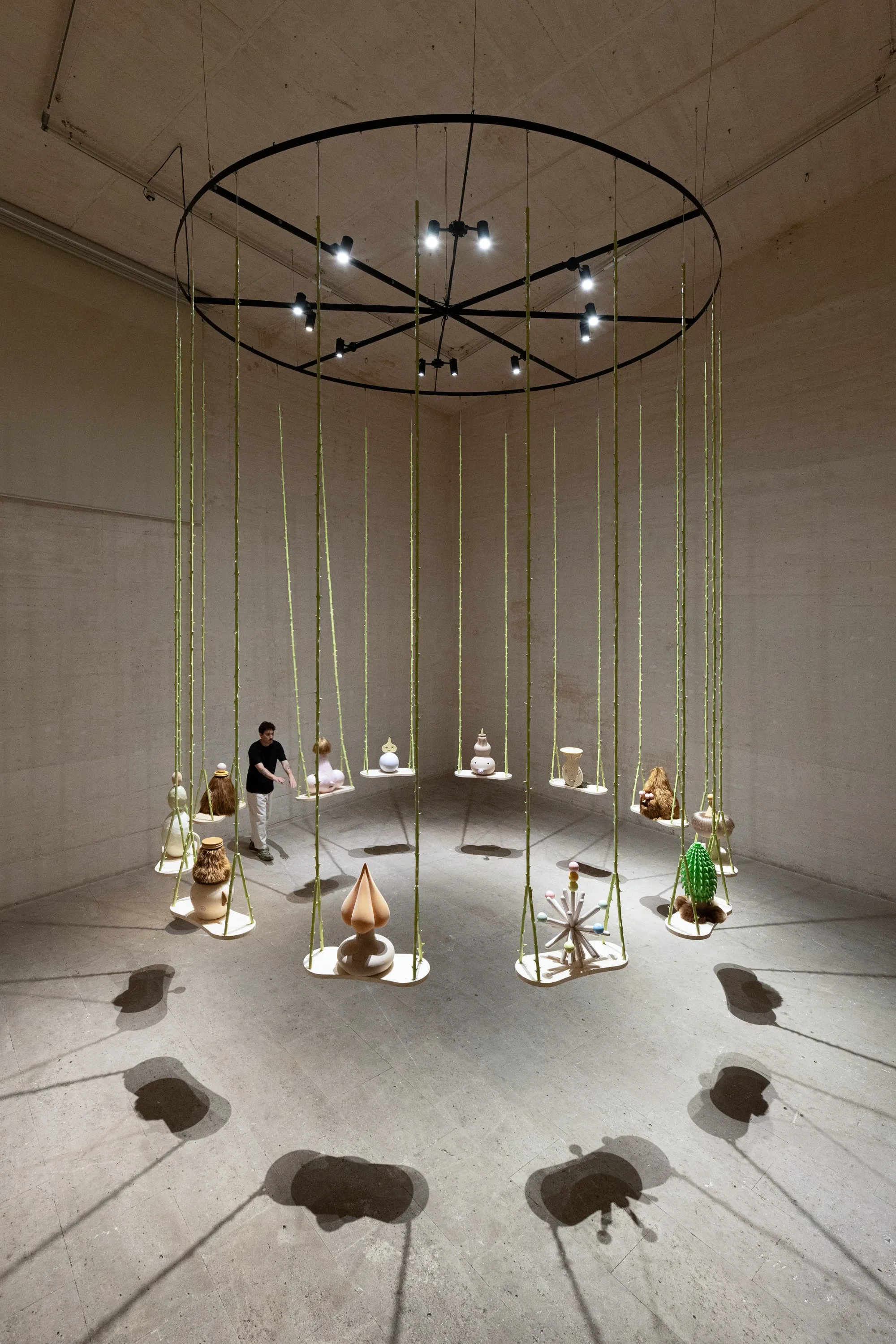 Grip Face, Utopía del Lodo y Sashimi de Bruma, installation detail of sculptural objects hanging on swings within circular exhibition layout, Miró Foundation Museum, Barcelona.