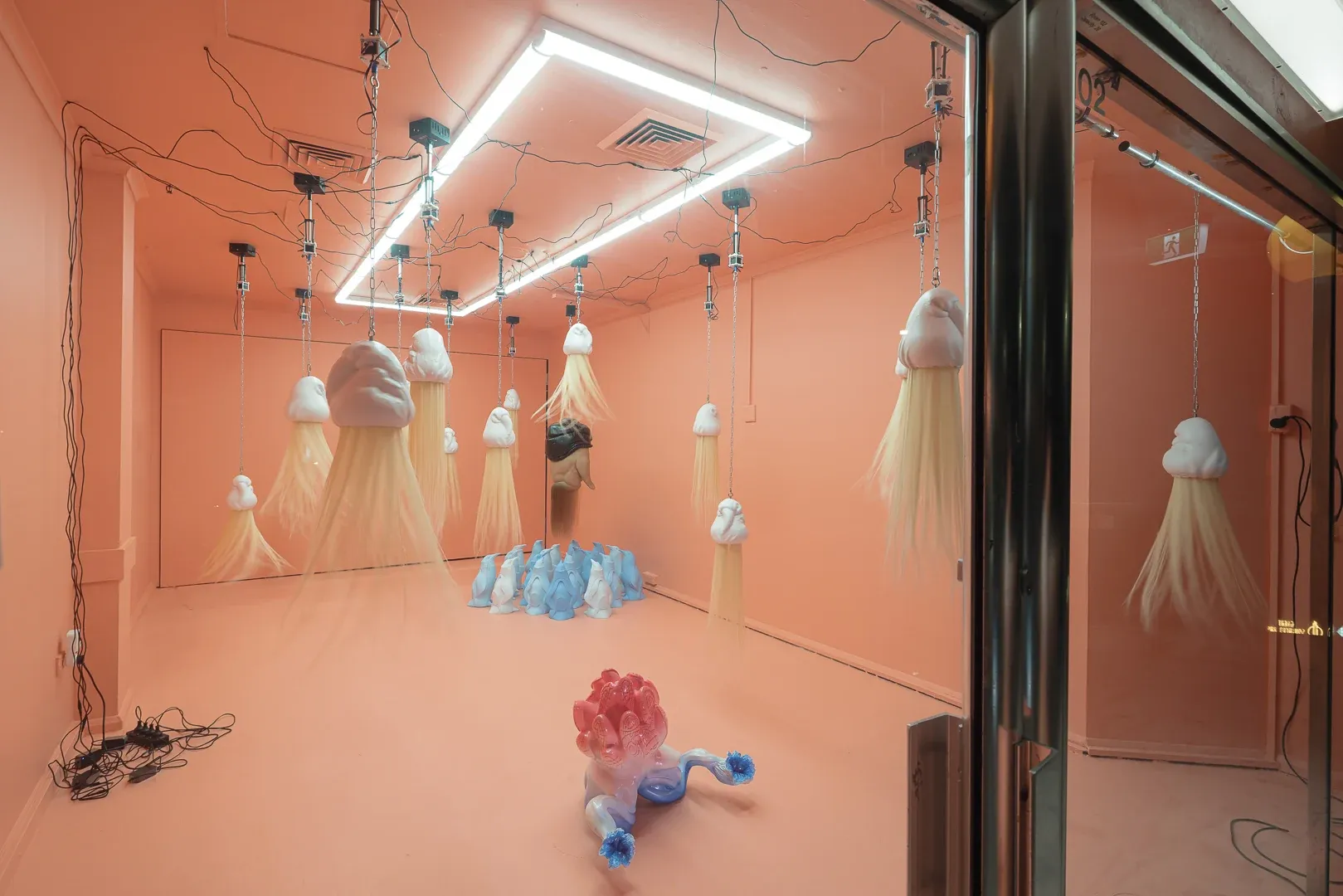 Passage Gallery Sydney exhibition view of Patricia Piccinini showing kinetic hanging sculptures and penguin installation in pink gallery spac