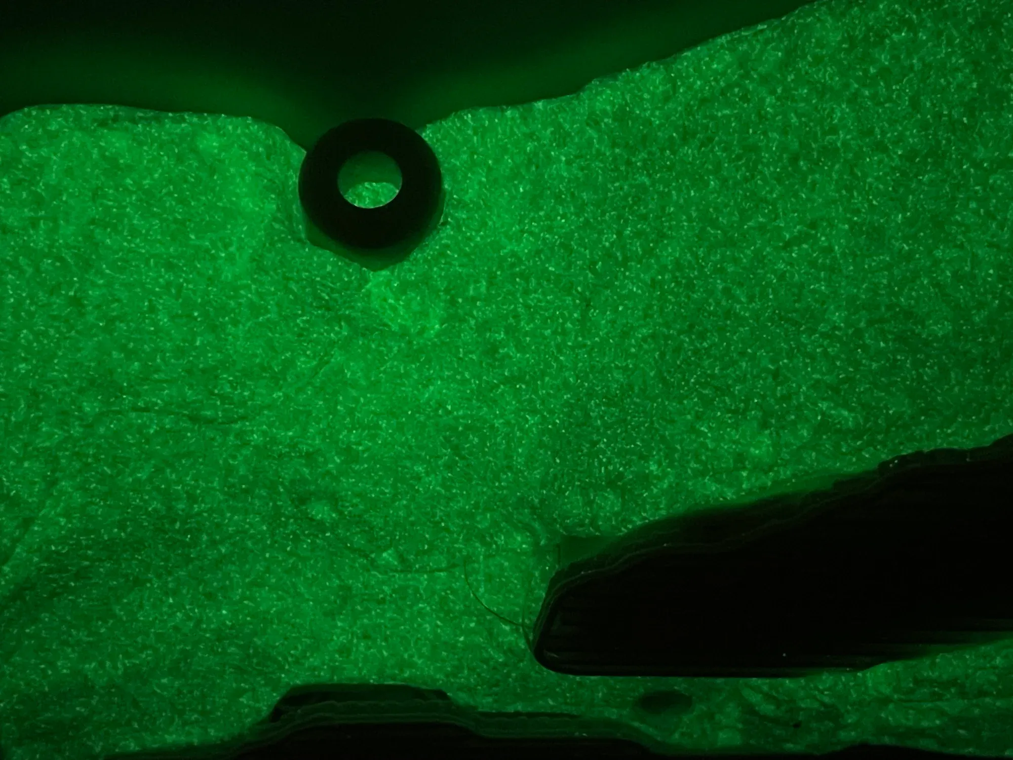 Yorgos Agrotes artwork Afentiko Affection (2025), foam sculpture with oil paint glowing in the dark and a 3D printed negative head element, green illuminated surface