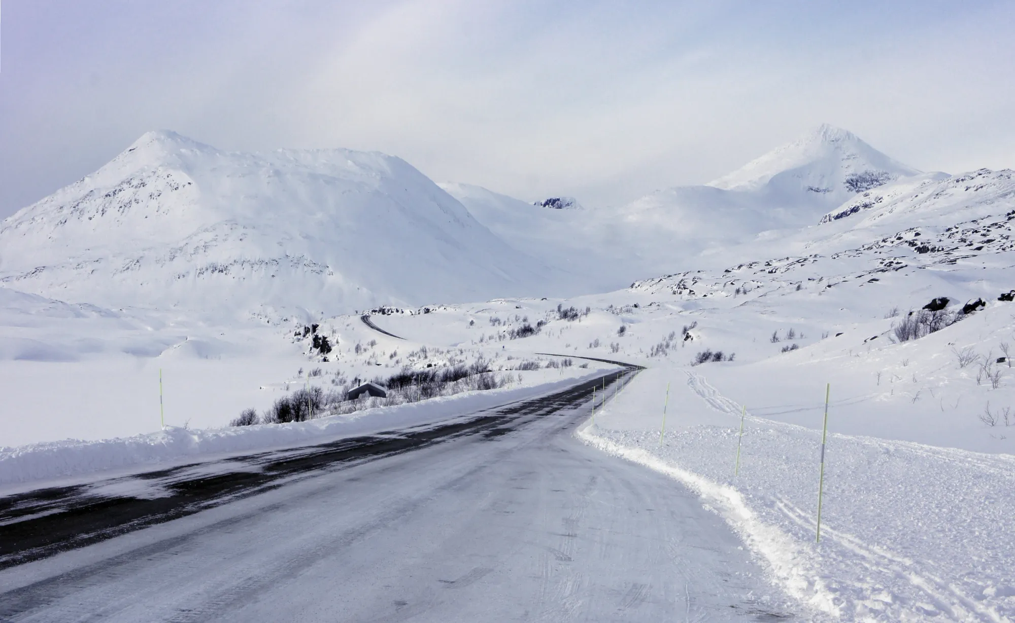 Andreas R Andersson Snow covered mountain landscape with winding road, Koulitisjaure 2023, winter scene, northern Sweden, Photo by Andreas R Andersson