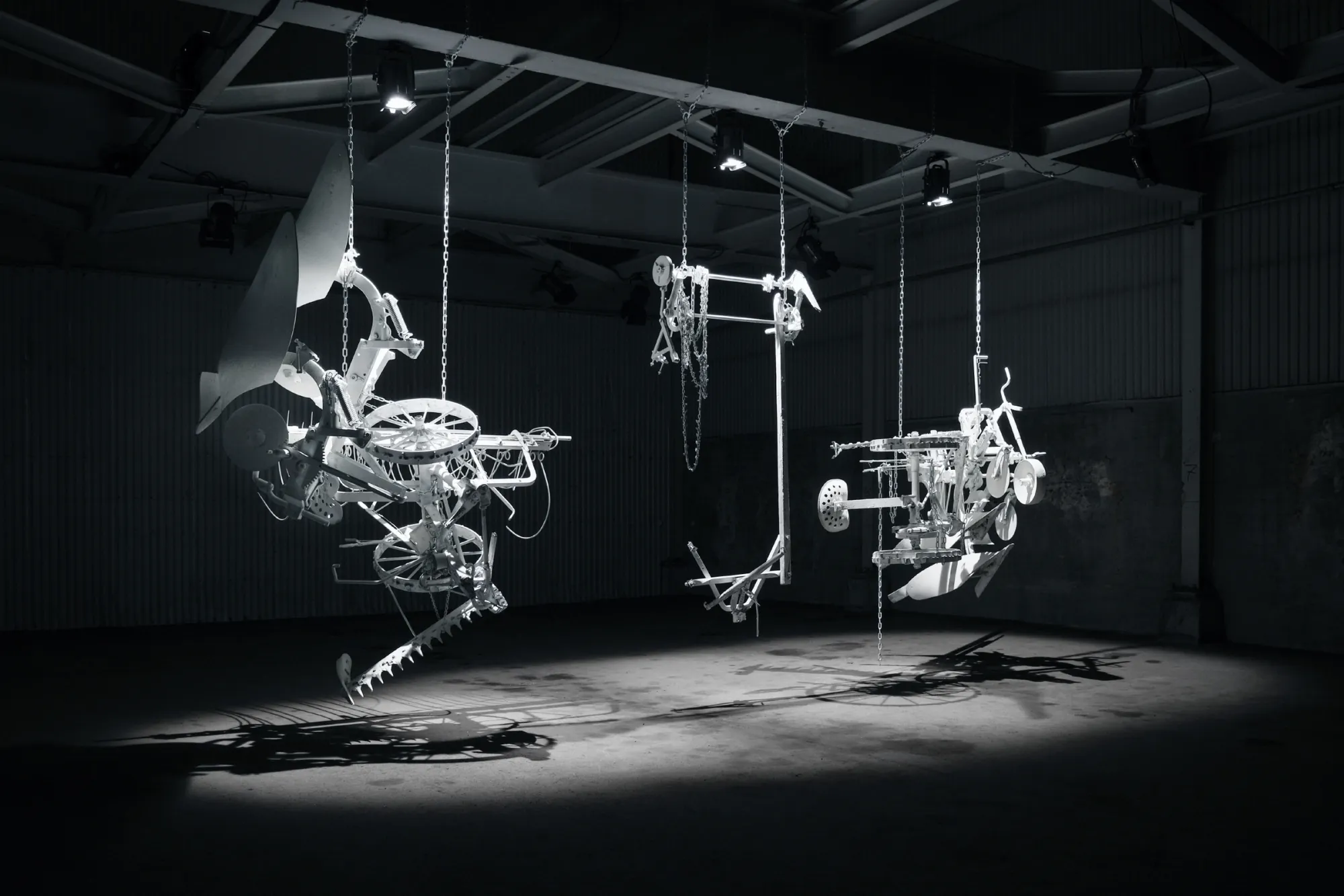 Hanging sculptural structures in dark space, A Barren Land Left in Dust, Kiruna Gamla fiskodlingen 2021, Photo by Konstfrämjandet Norrbotten