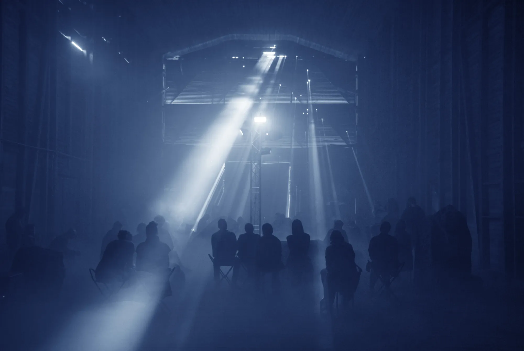 Andreas R Andersson art installation , Dark installation with seated audience and dramatic lighting, Beowulf by Andreas R Andersson, Boden 2024, Photo Thomas Hämén