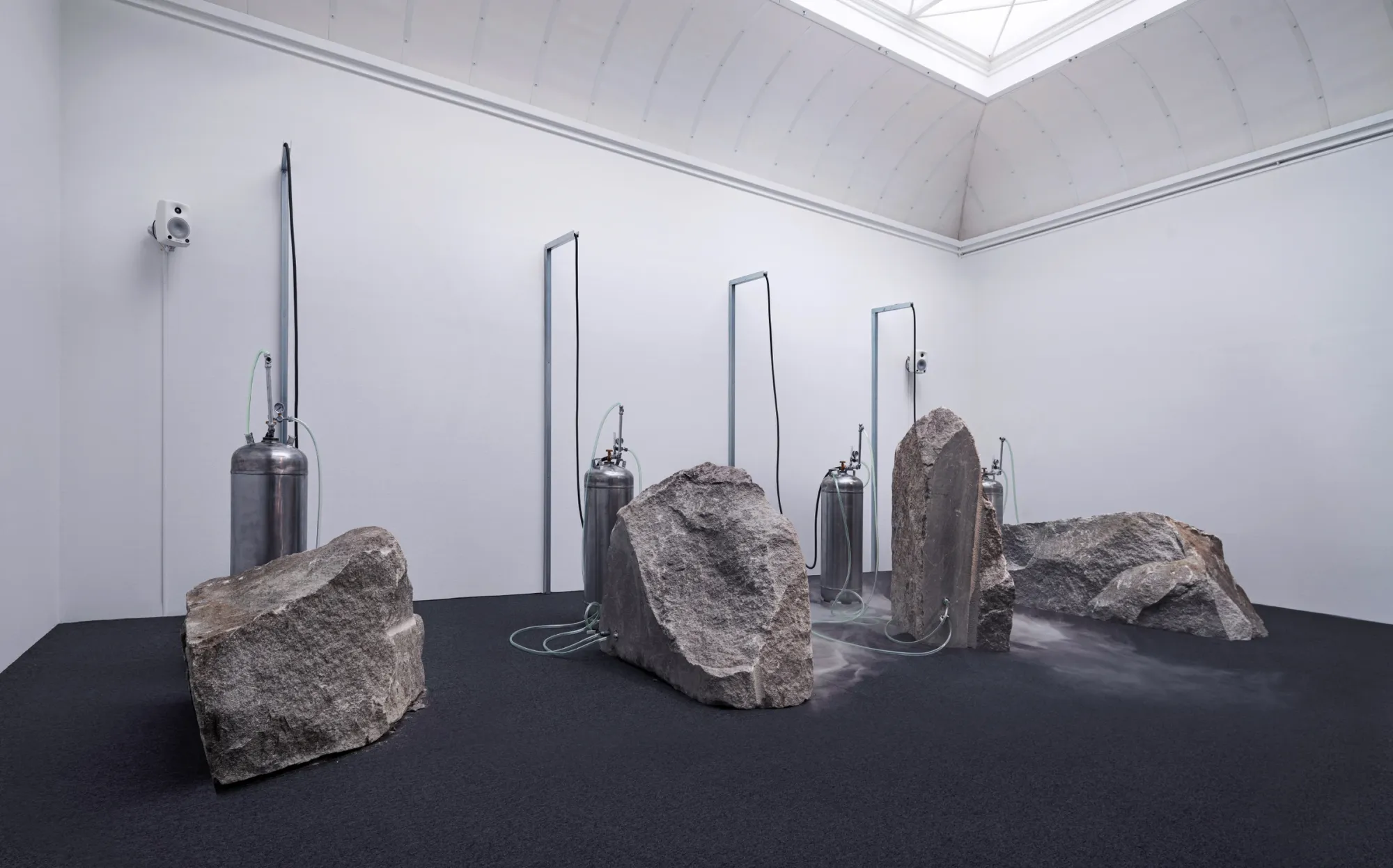 Stone sculptures connected to industrial containers, exhibition view A Burning Crust on Life Support, Gothenburg 2022, Photo Hendrik Zeitler